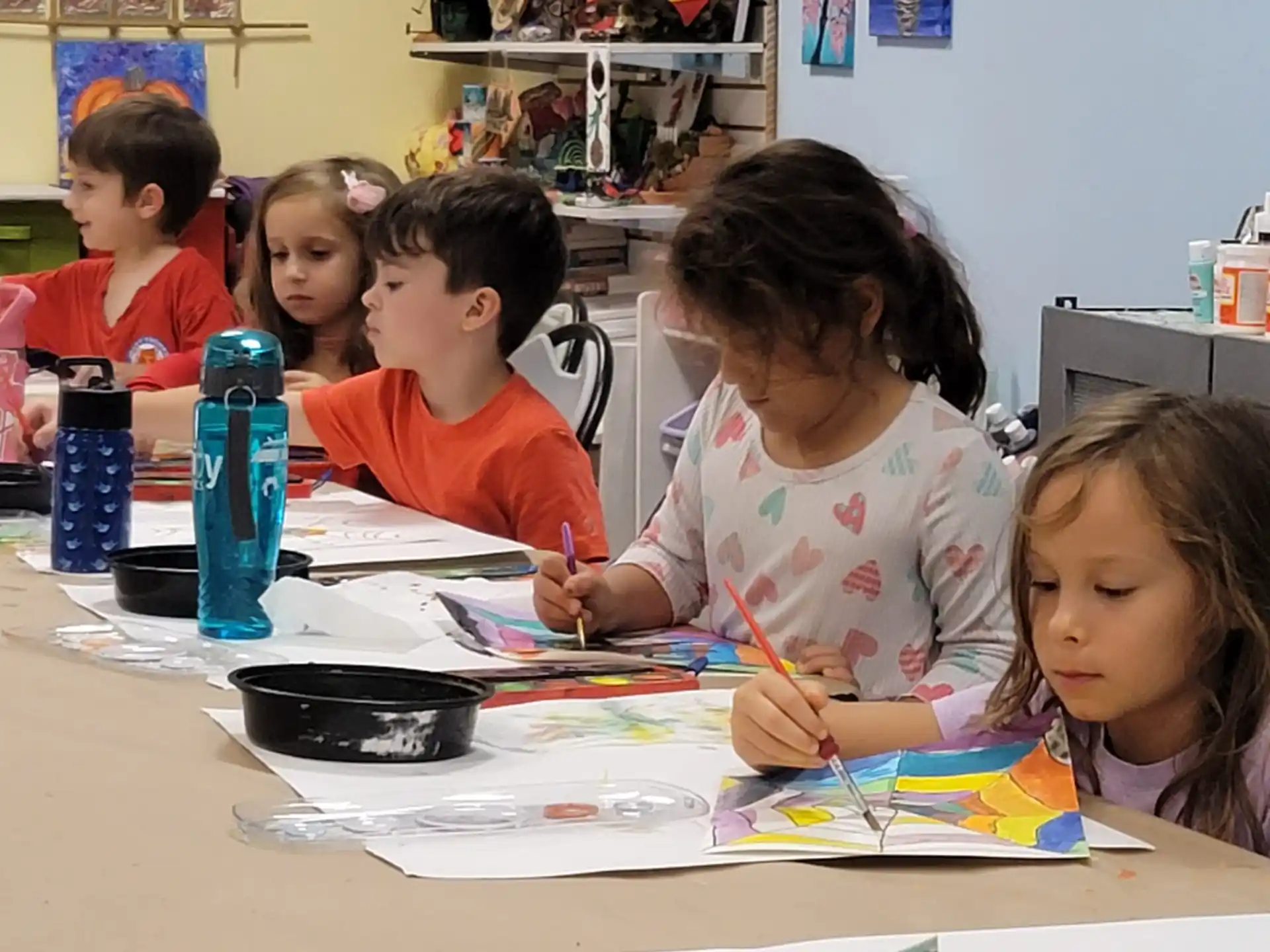a group of children sitting at a table