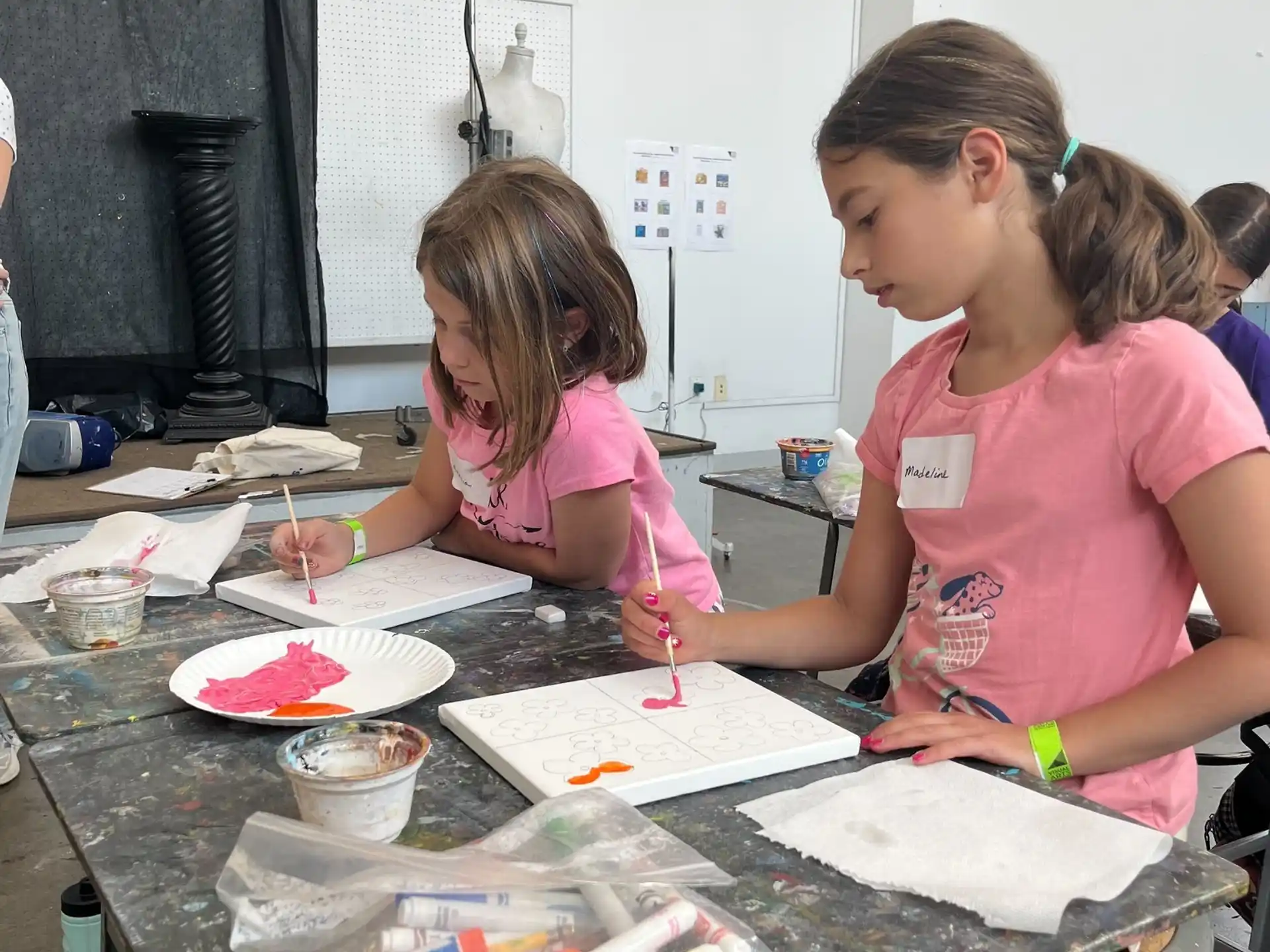 a few young girls painting