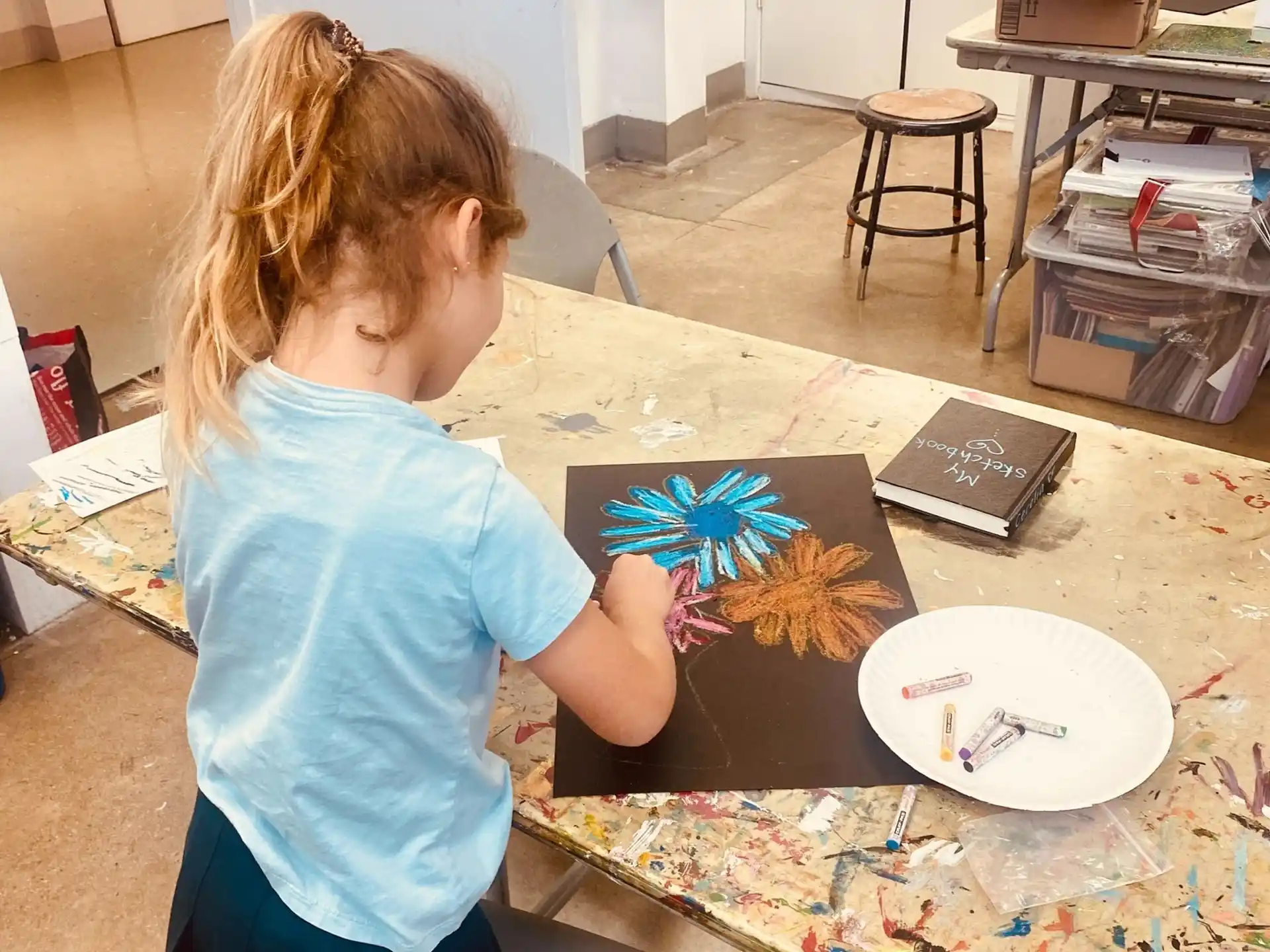 a girl painting on a table
