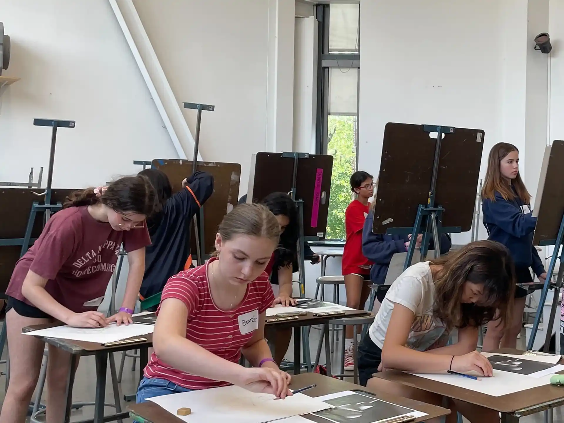 a group of people sitting at desks in a room