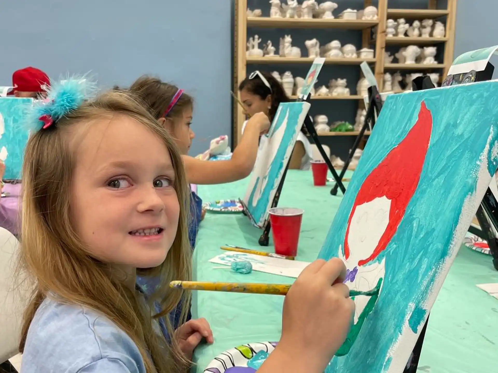 a girl holding a blue board
