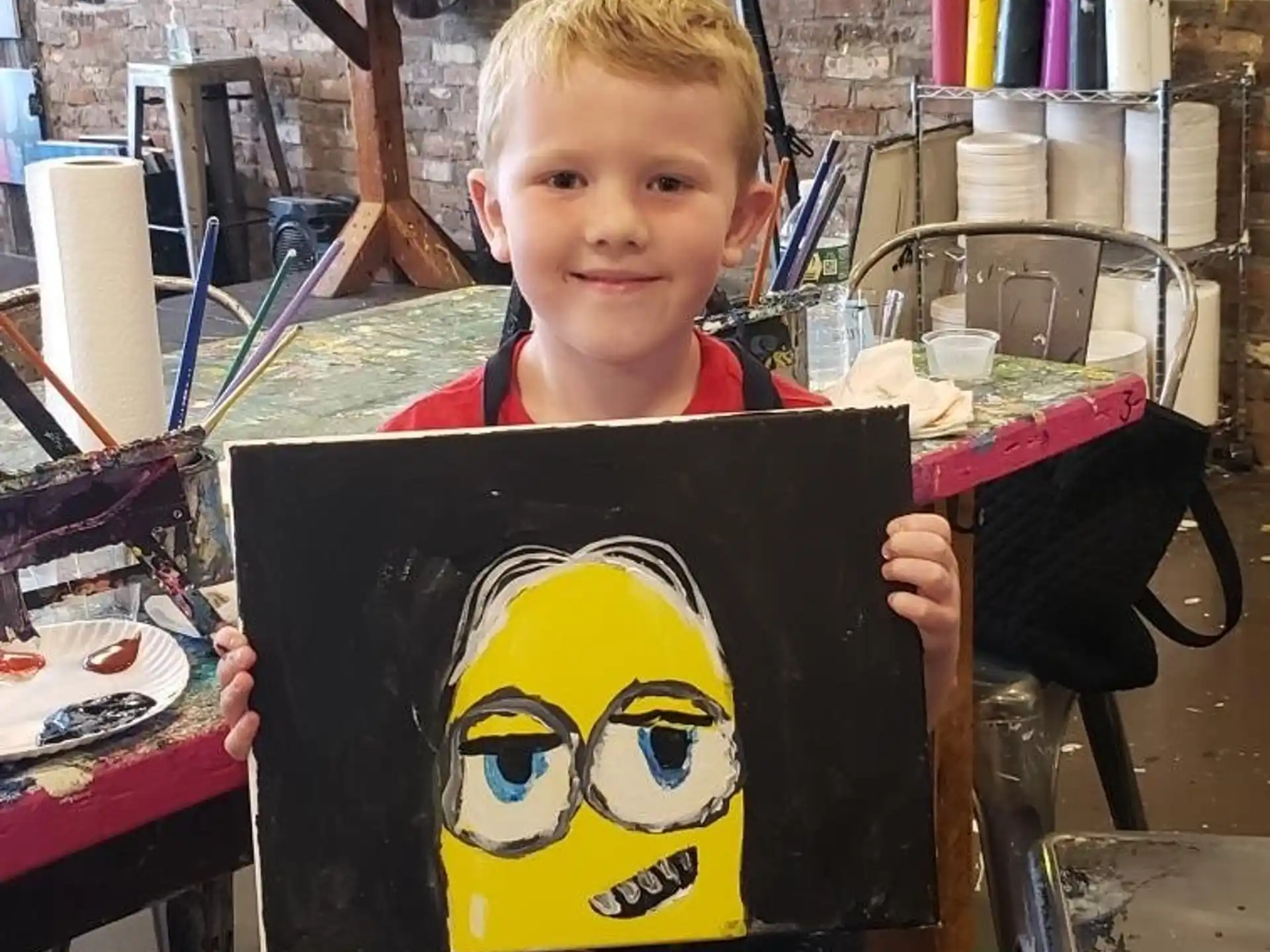 a boy holding a drawing