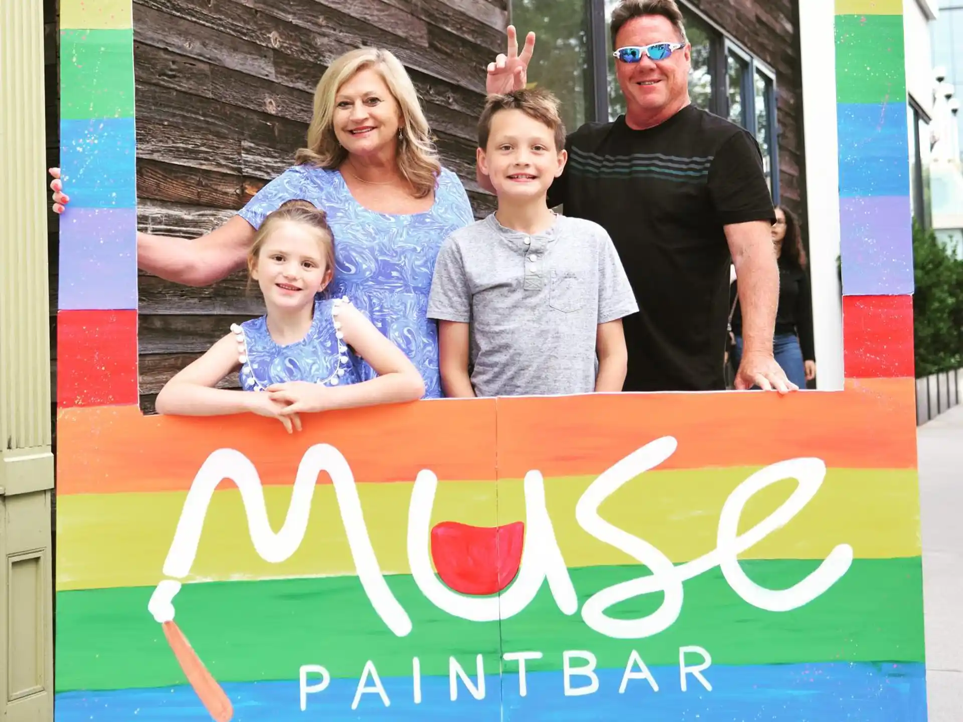 a group of people posing for a photo in front of a sign