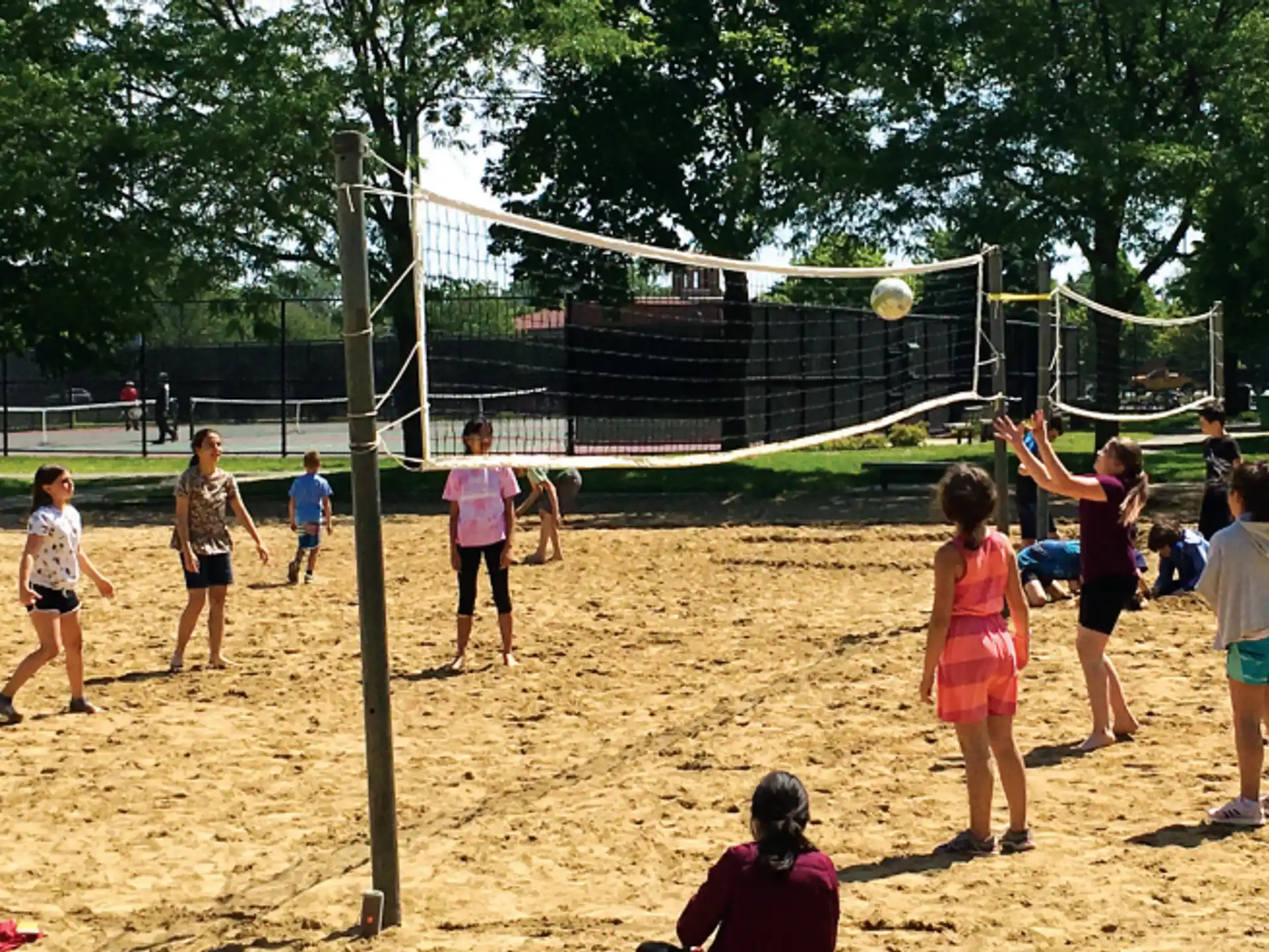 a group of people playing volleyball