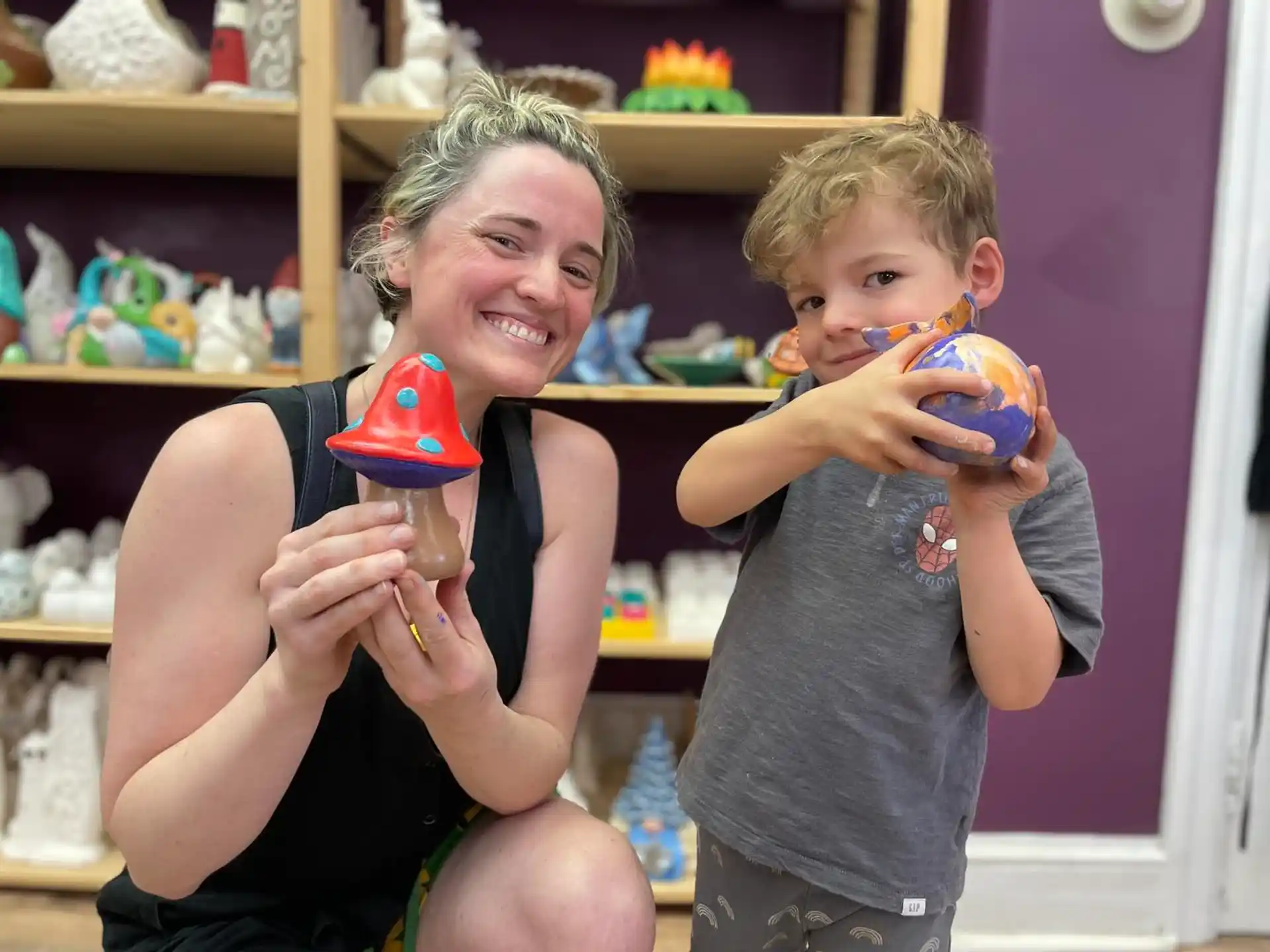 a person and a boy holding toys