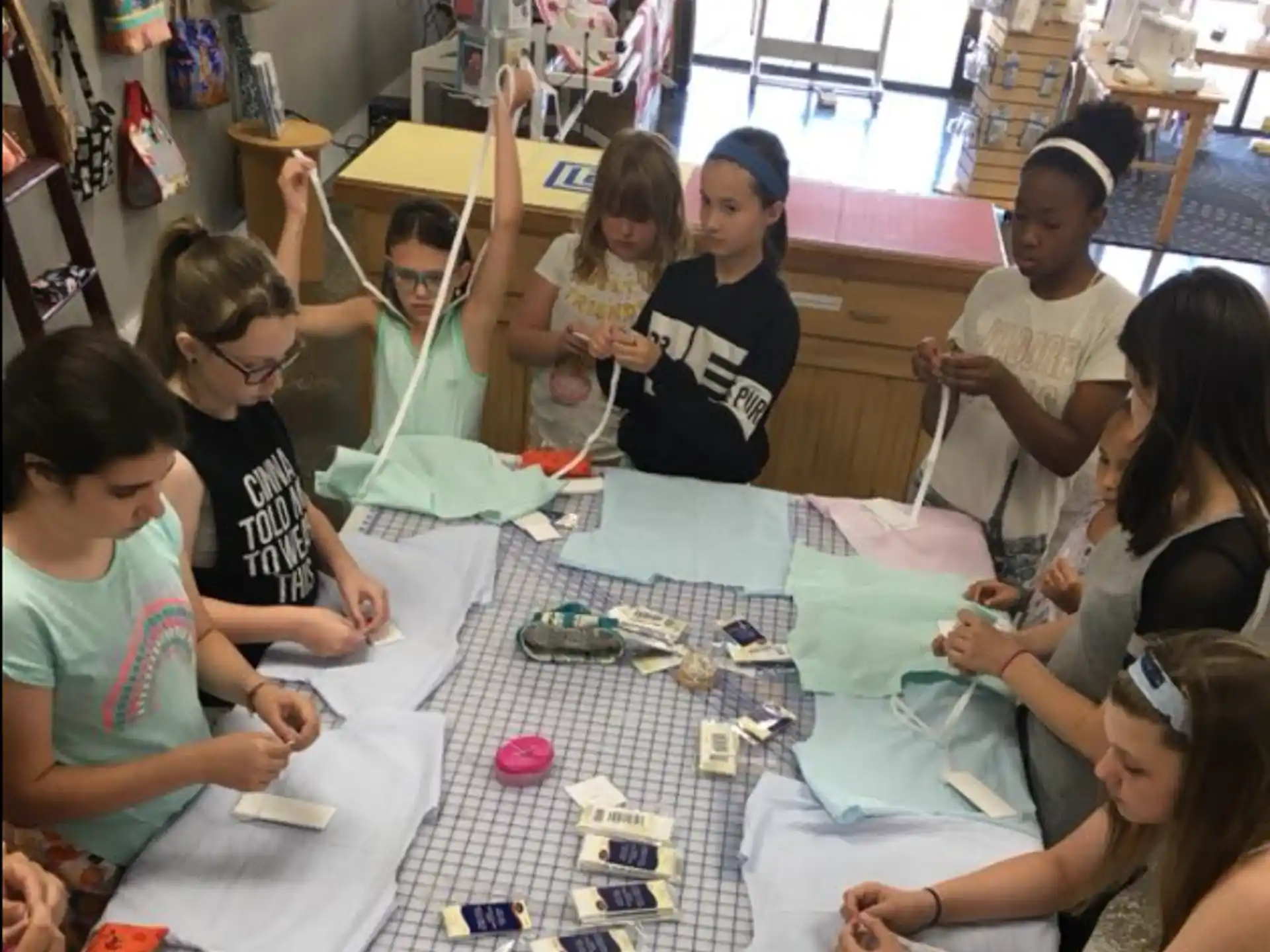 a group of children sitting around a table