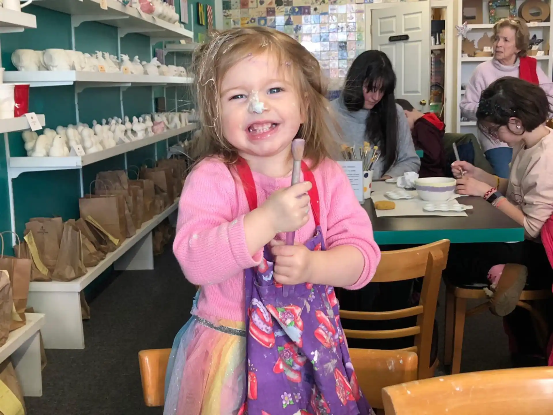 a girl holding a toy