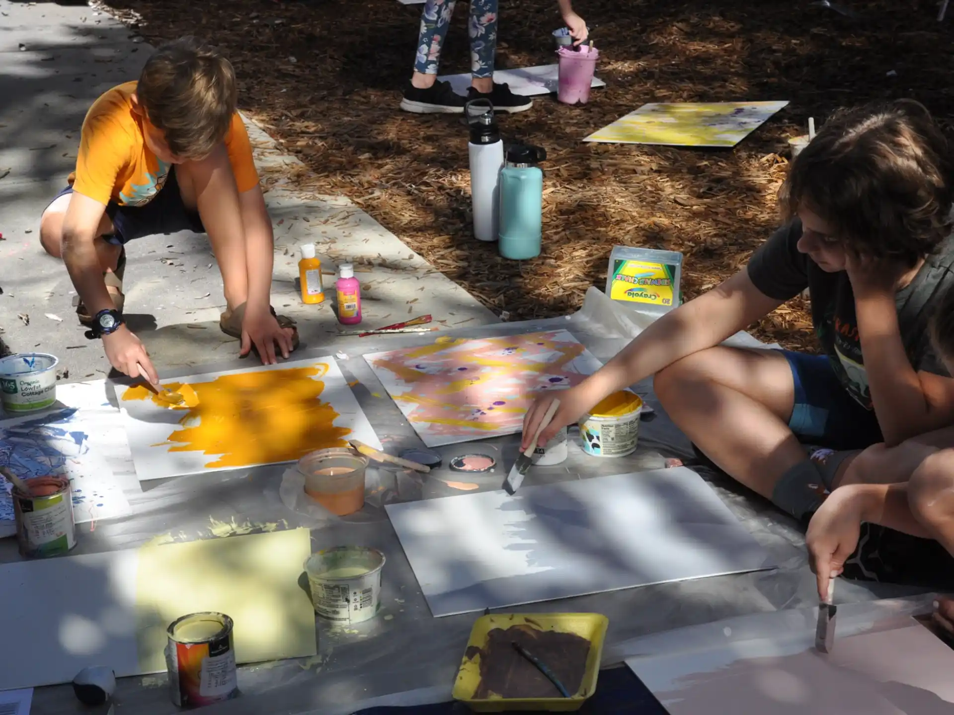 a group of people painting on the ground