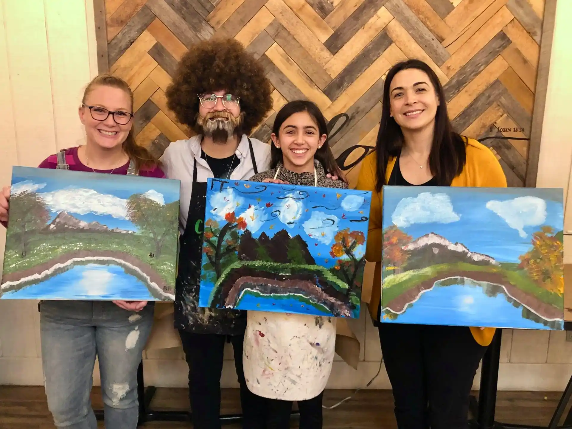 a group of people holding paintings
