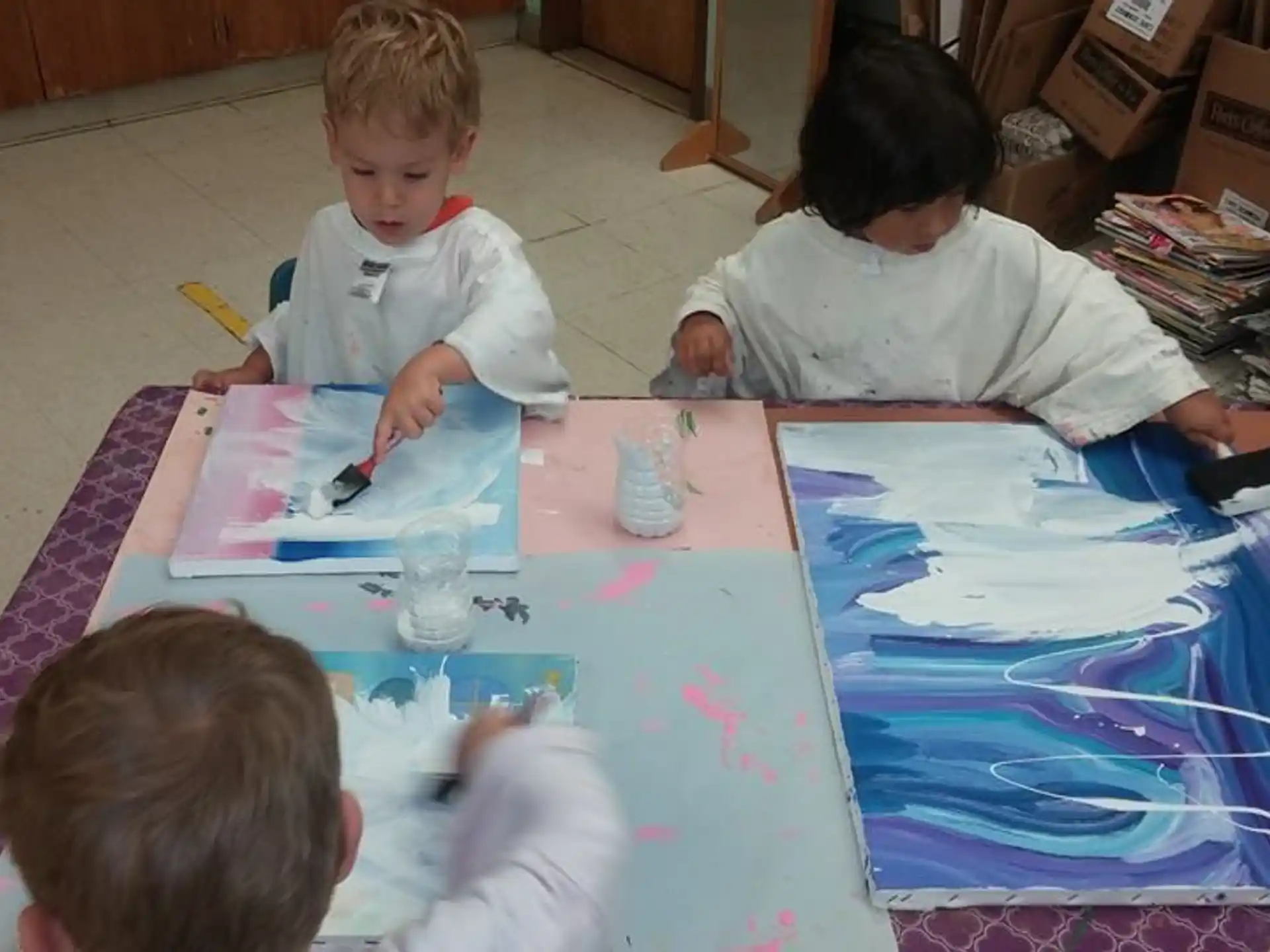 a group of children painting
