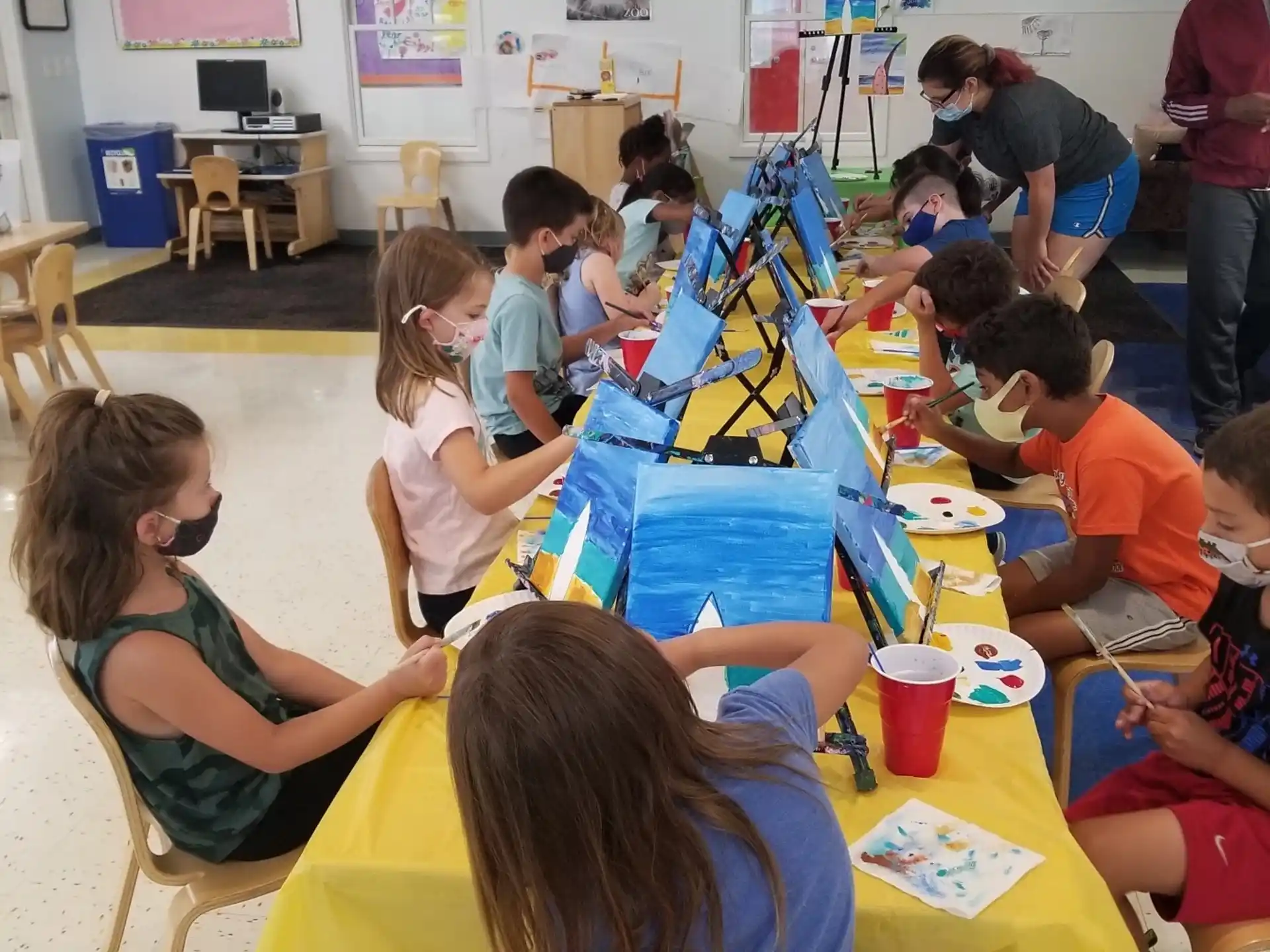 a group of children sitting at a table
