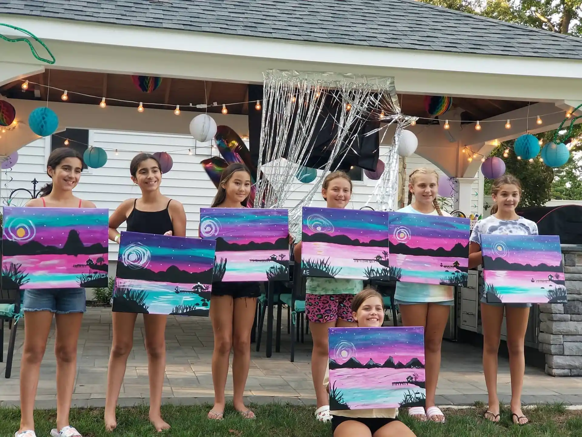 a group of girls holding up a sign