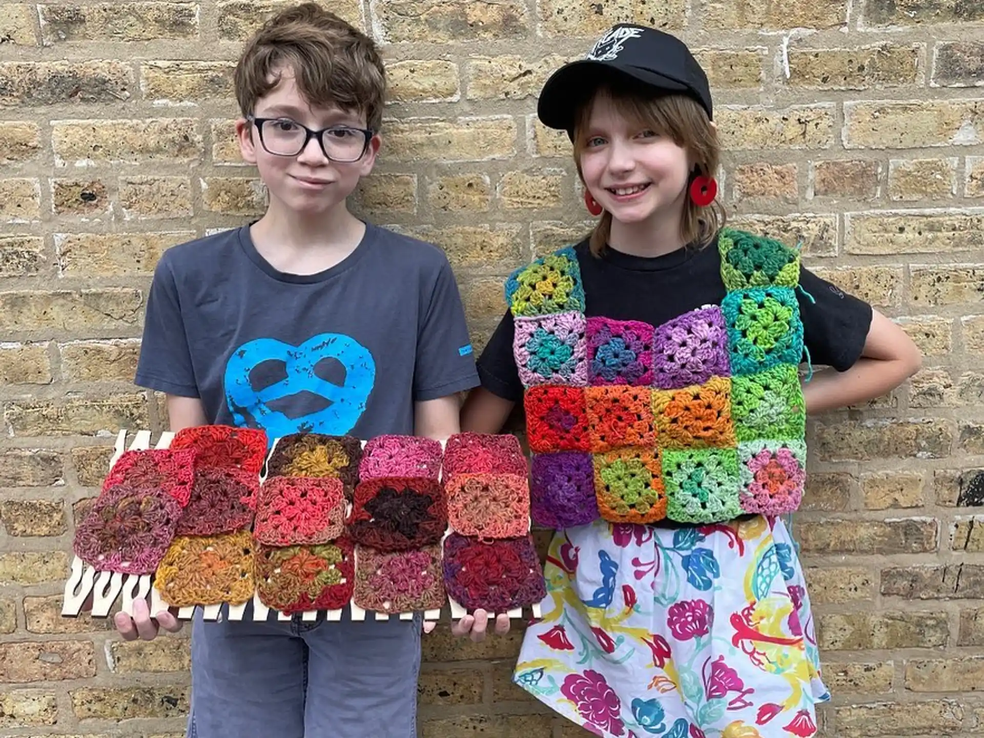 a couple of kids holding cupcakes