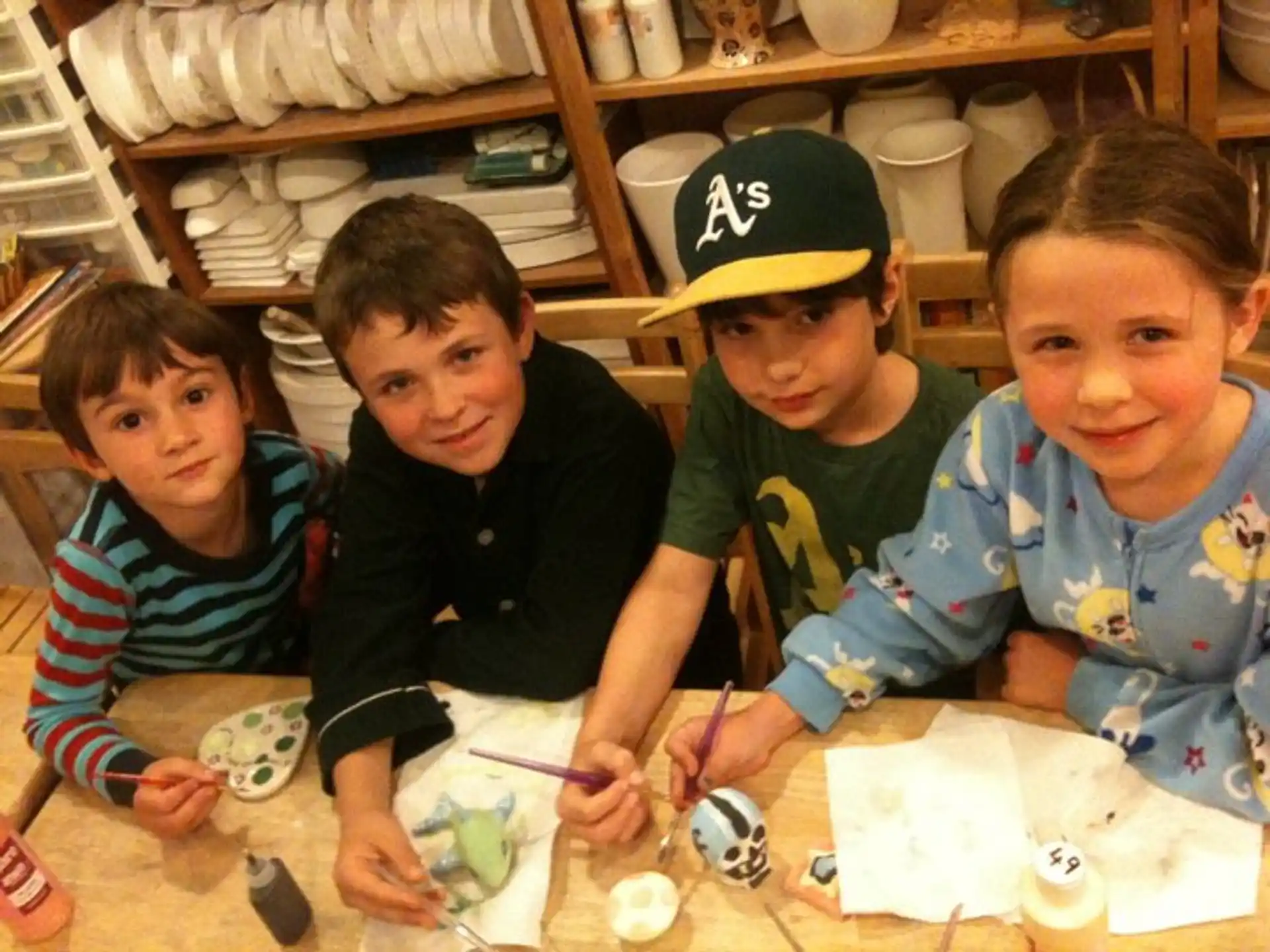 a group of kids sitting at a table