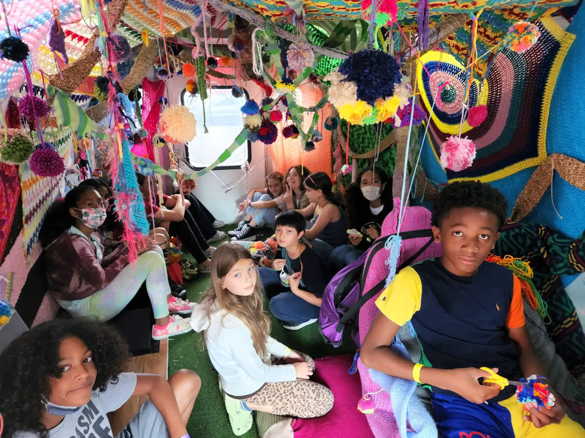 a group of people sitting in a room with colorful walls