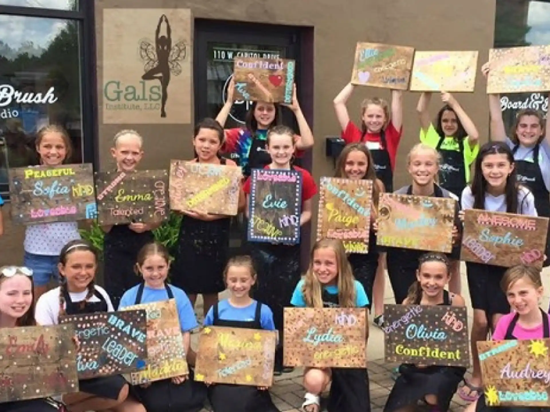 a group of children holding signs