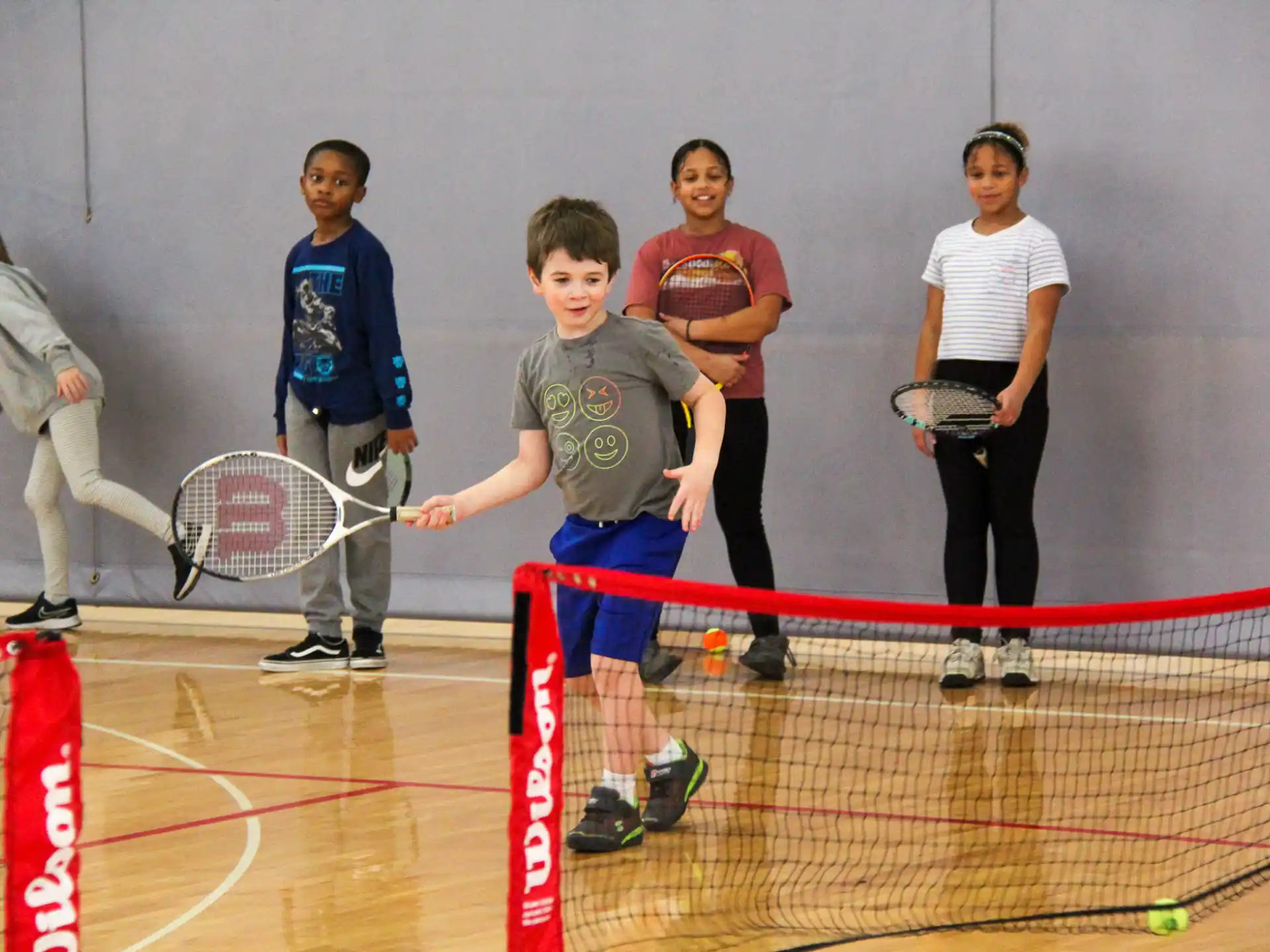 a group of people holding tennis rackets