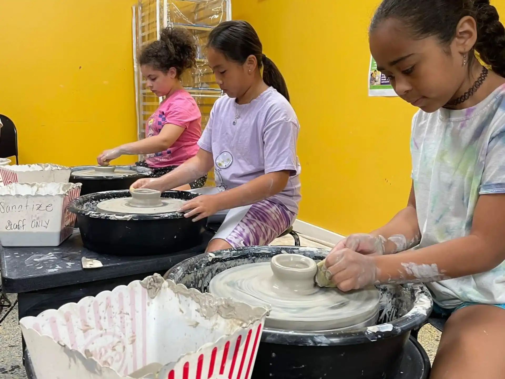 a group of girls cooking in a kitchen