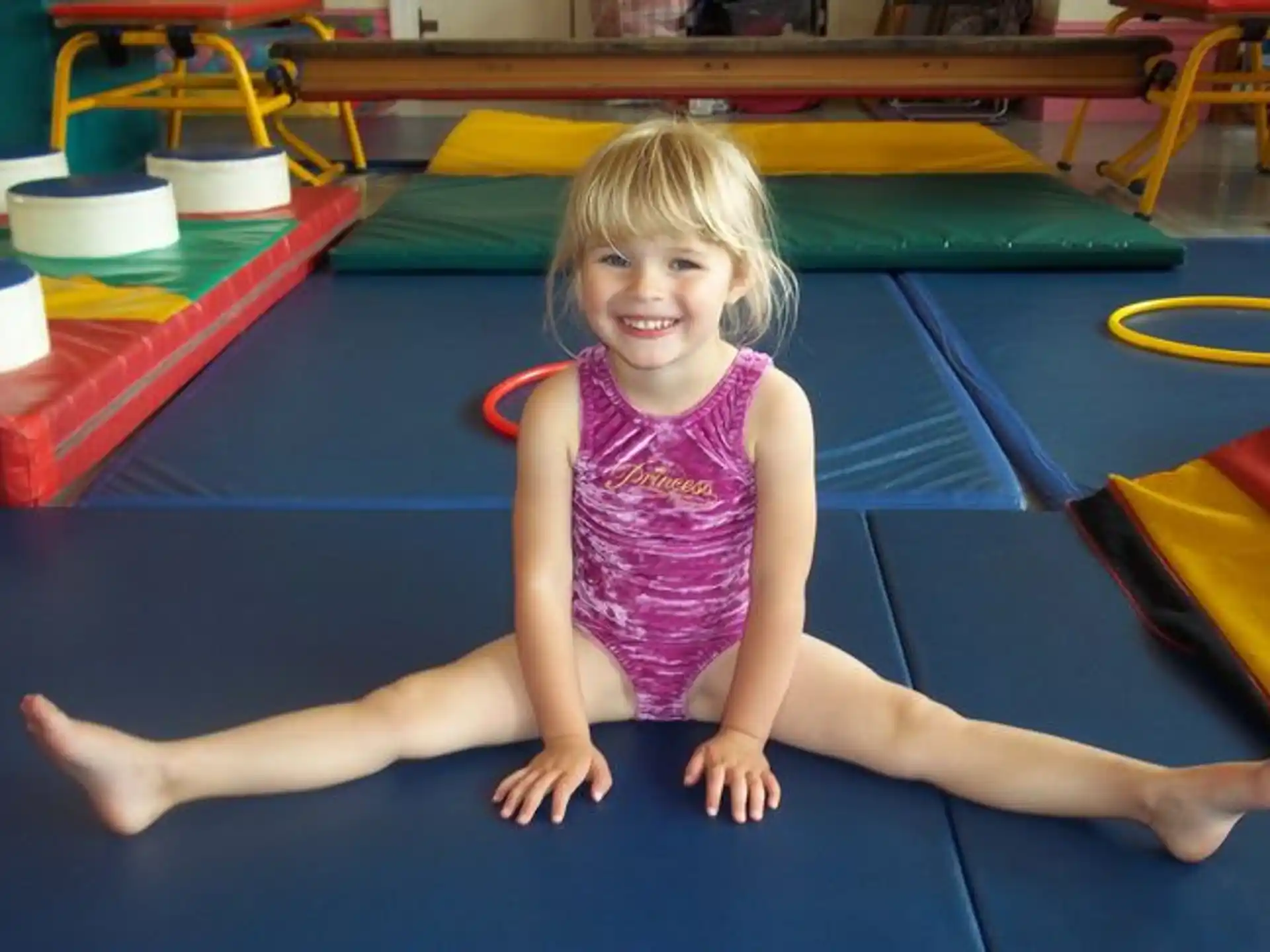 a girl sitting on a mat