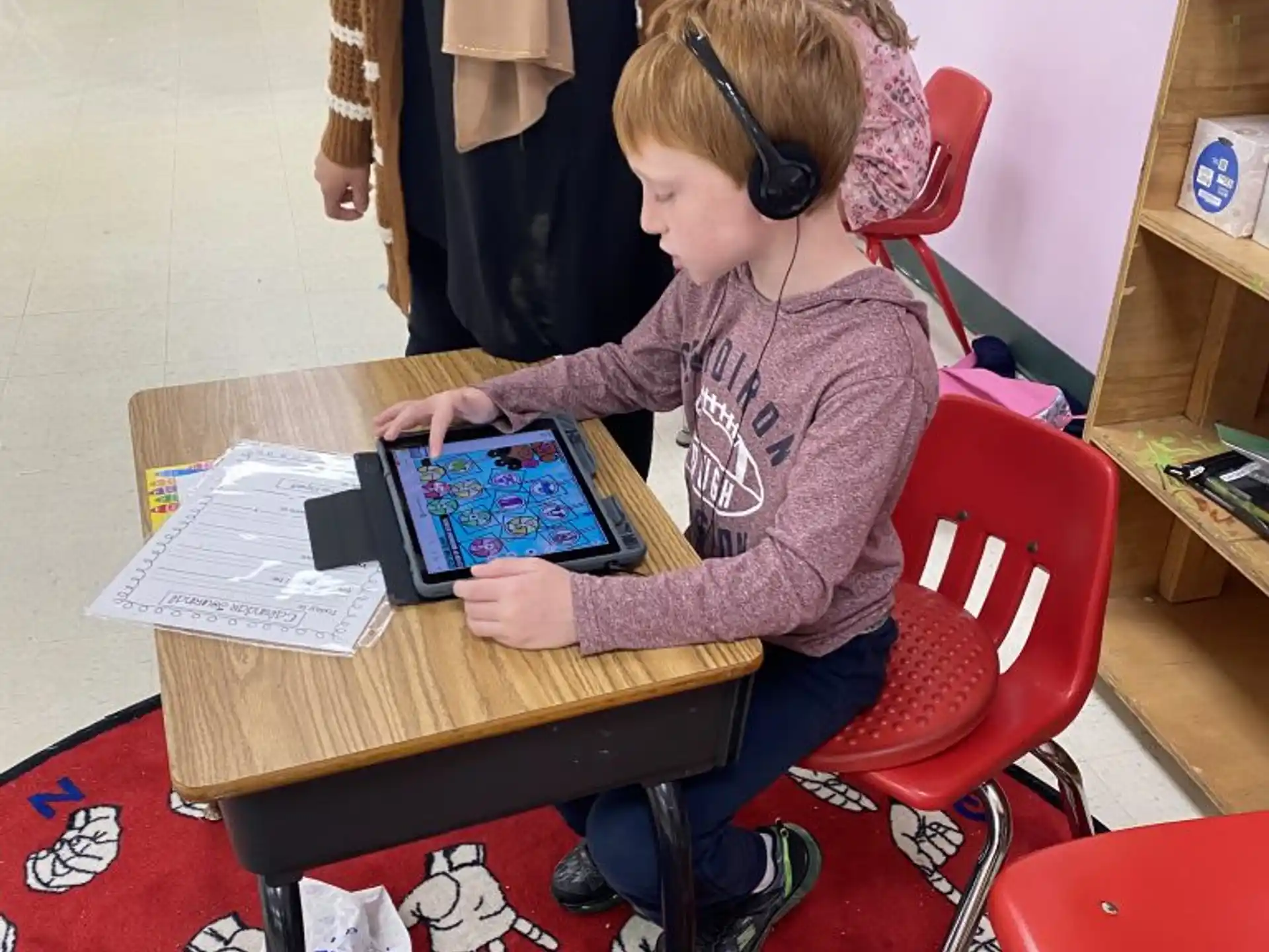 a person sitting at a table with a book and headphones on