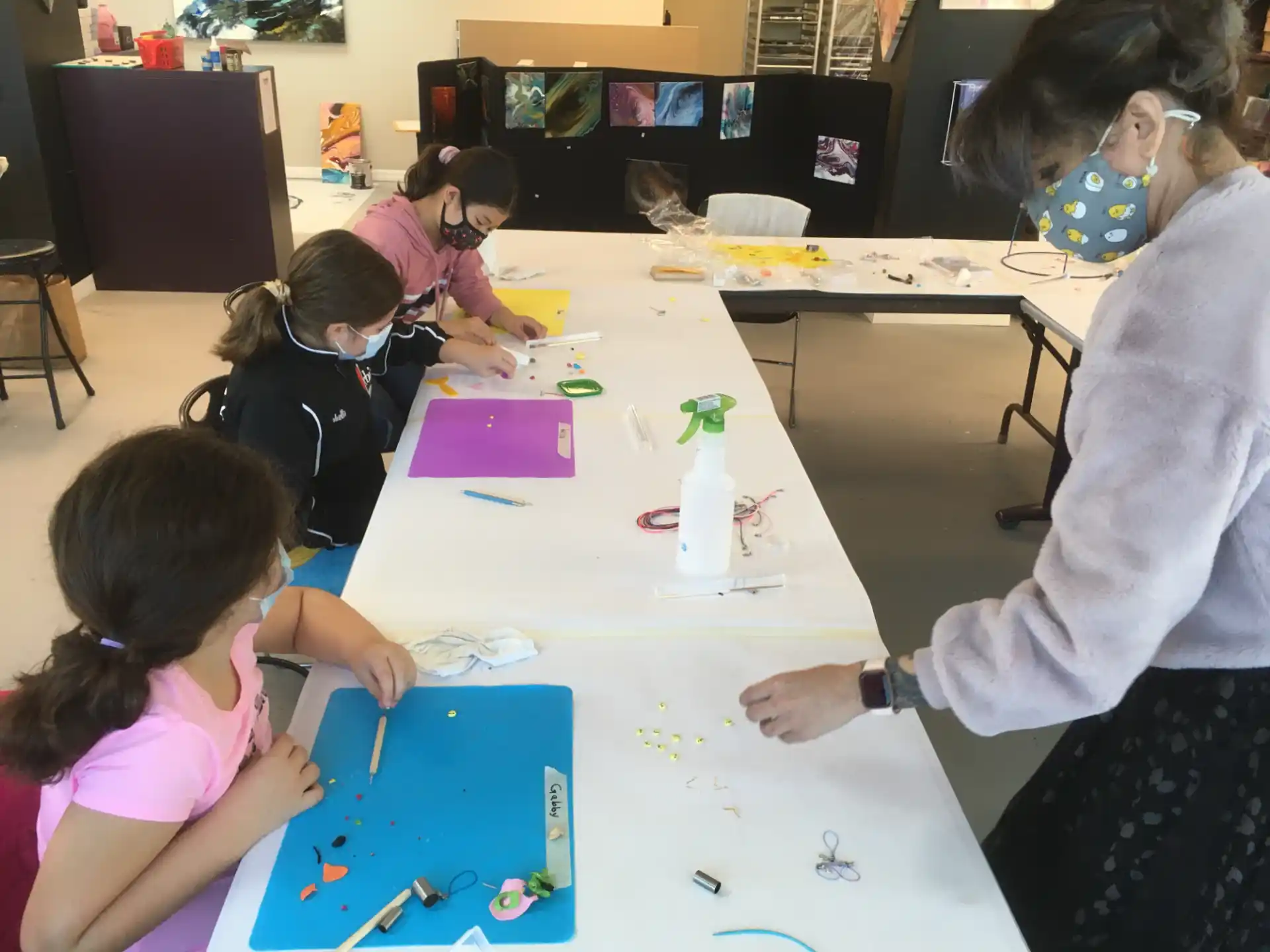 a group of people sitting around a table with colored paper on it