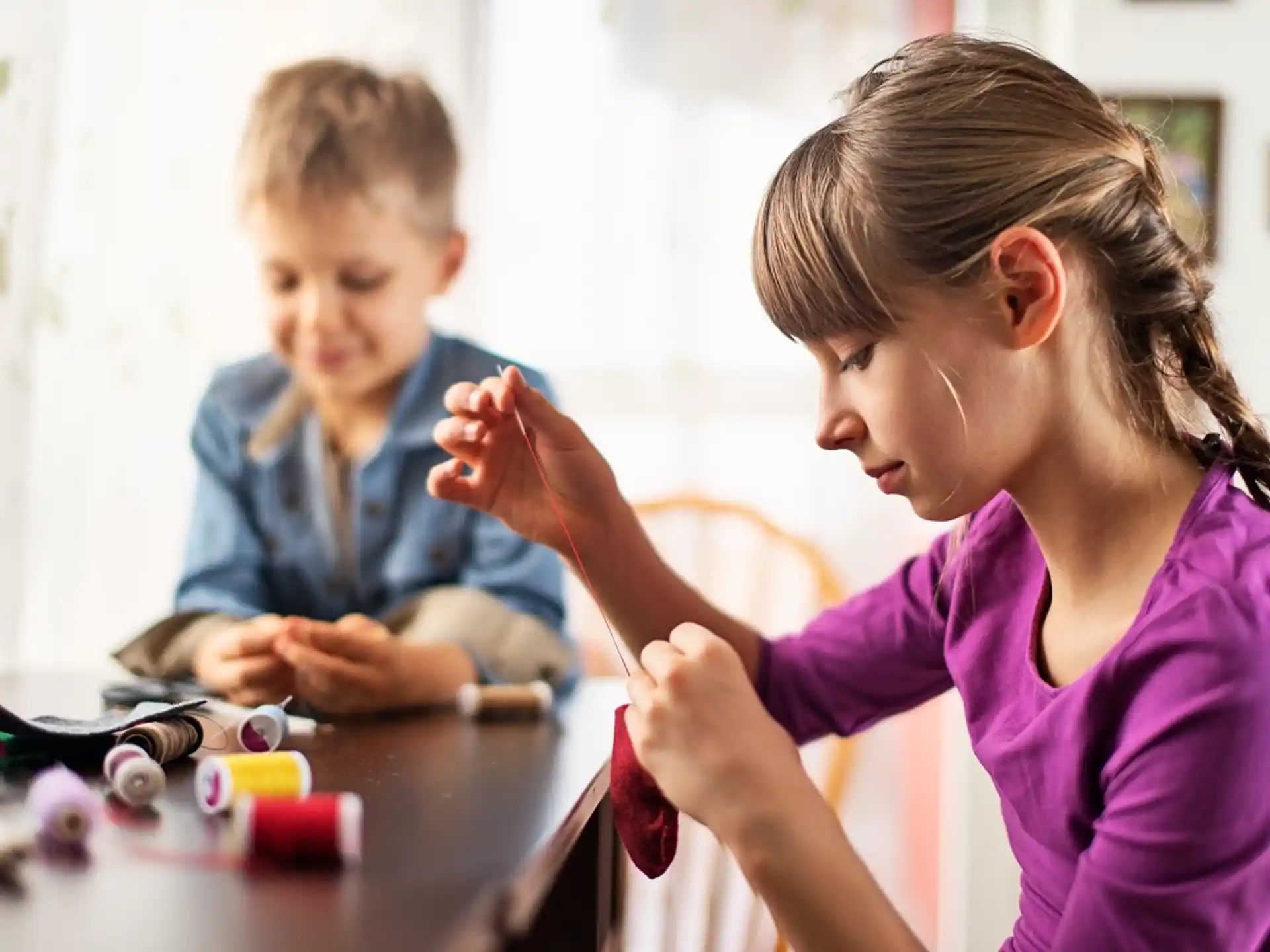 a young girl and a young boy playing with toys