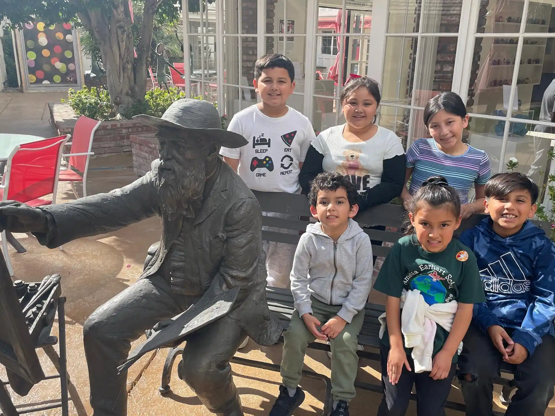 a group of people posing with a statue