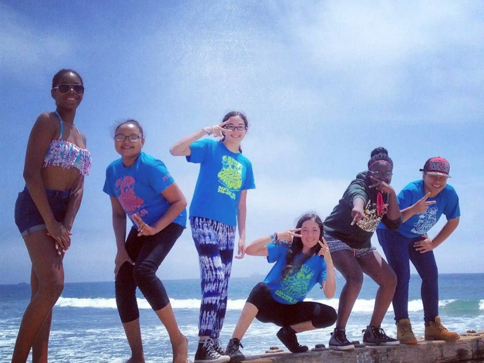 a group of people posing for a photo on a beach