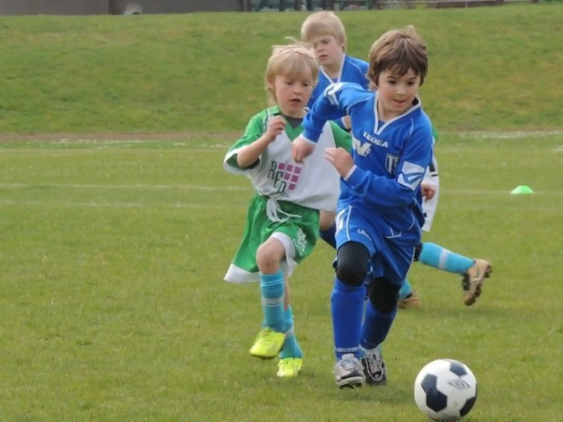 a group of kids playing football