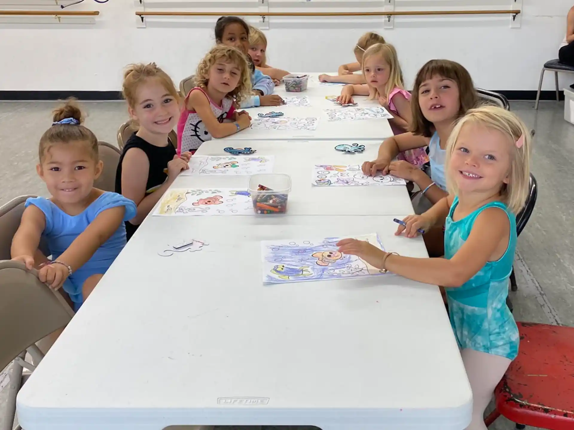 a group of children sitting around a table