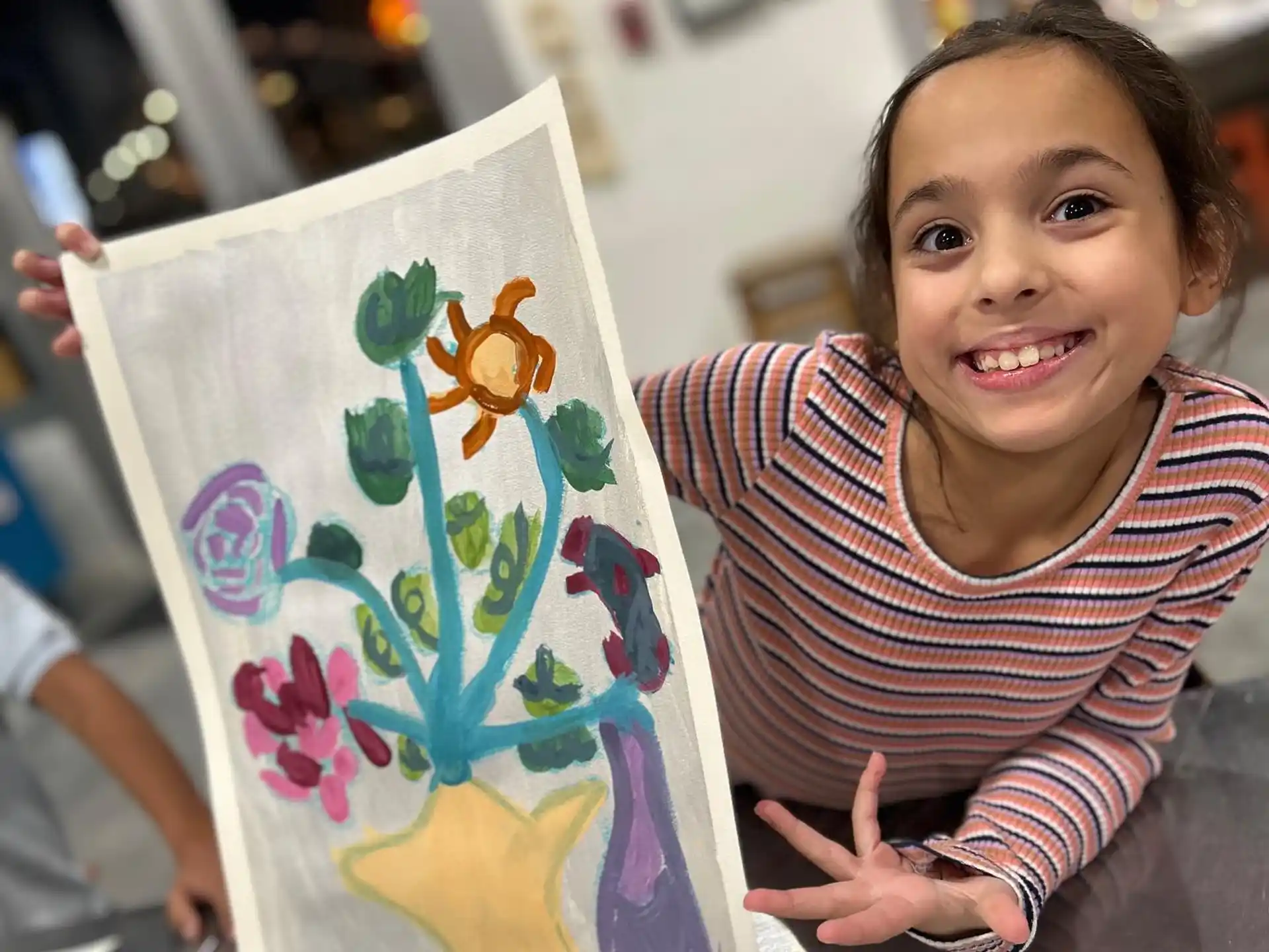 a child holding a painting