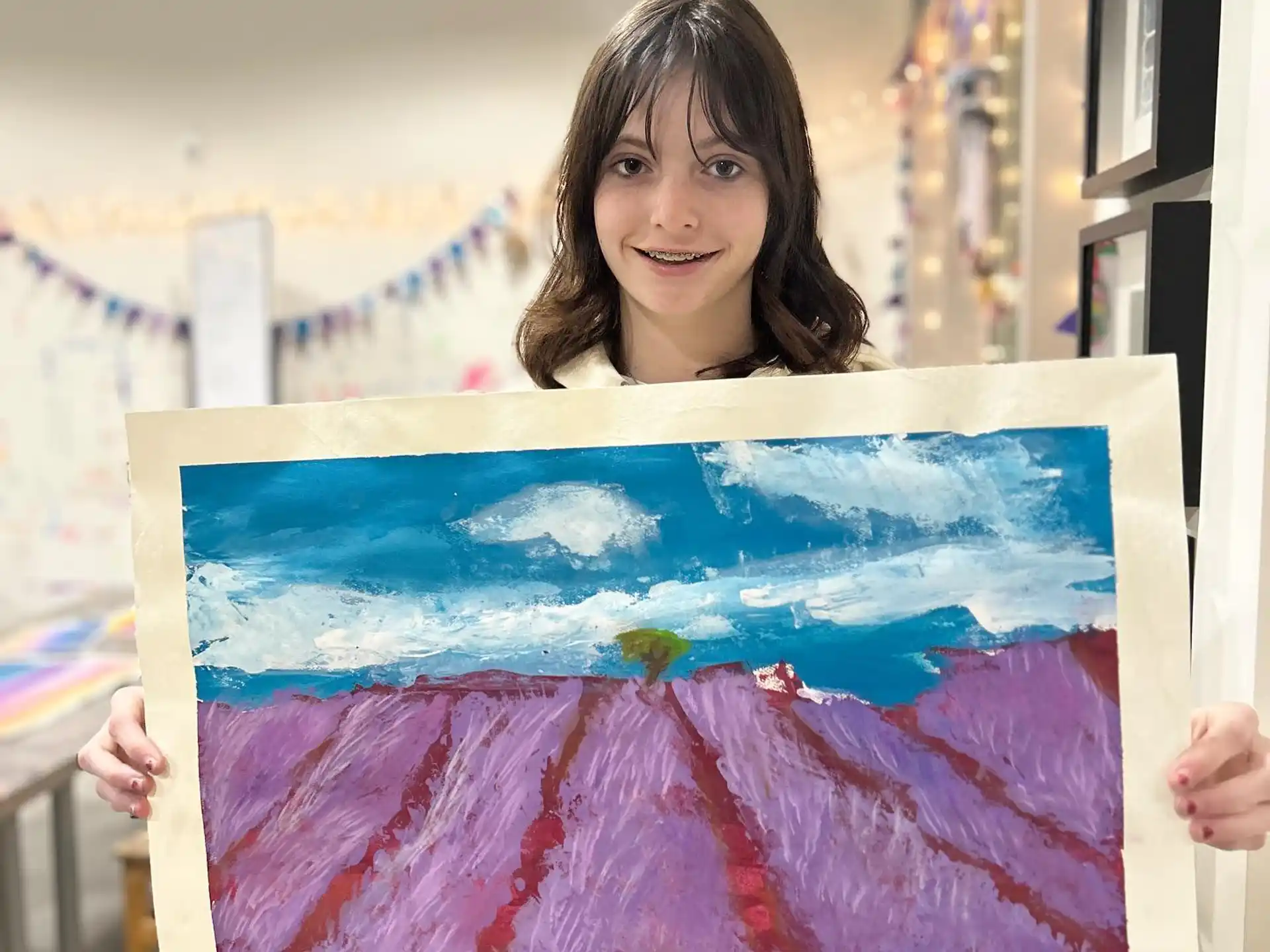 a person holding a large piece of art