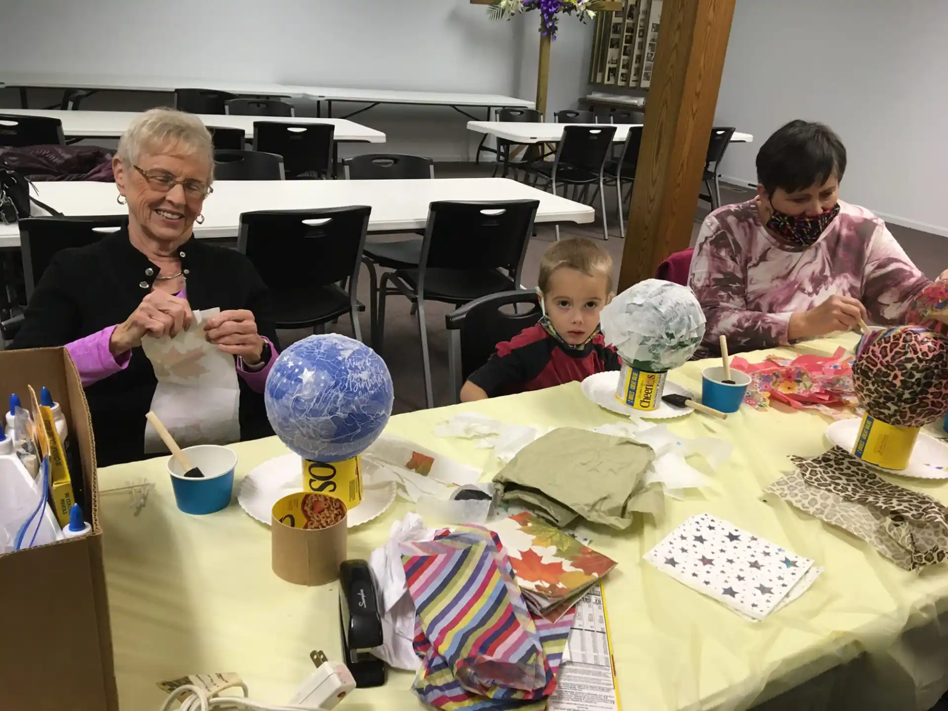 a person and a child sitting at a table with a child
