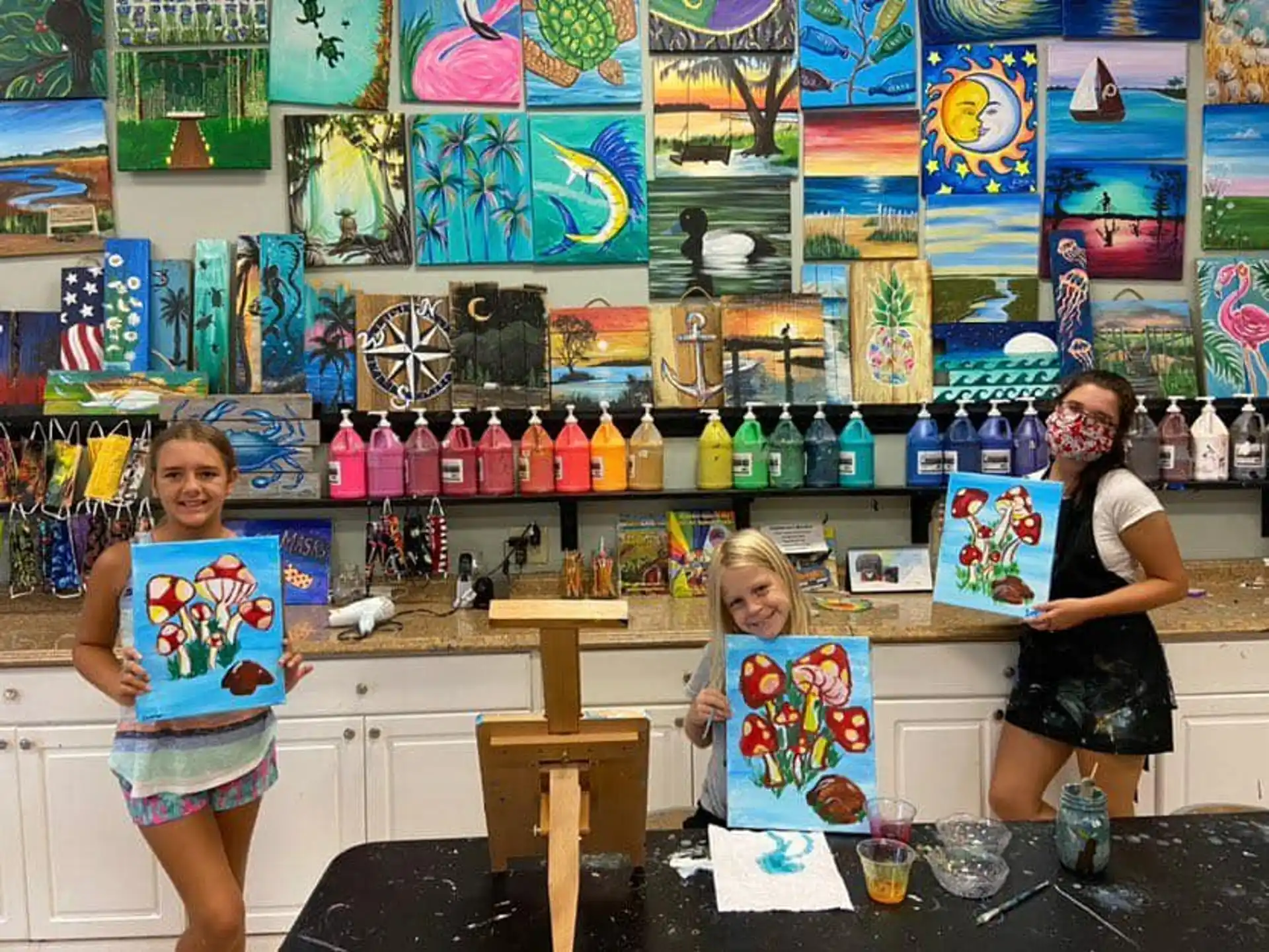 a person and a child in a room with a wall of bottles