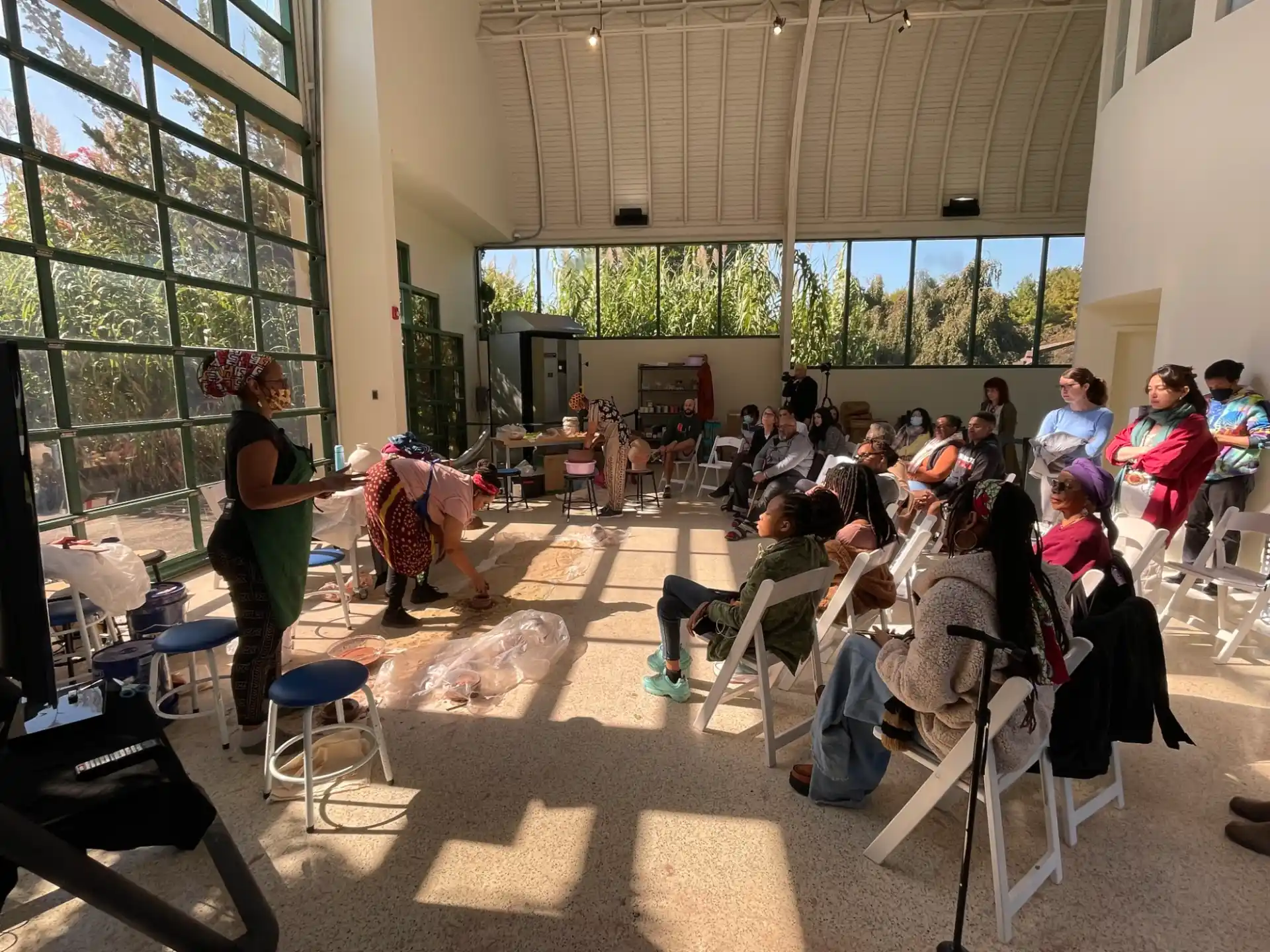 a group of people sitting in a room with chairs and tables
