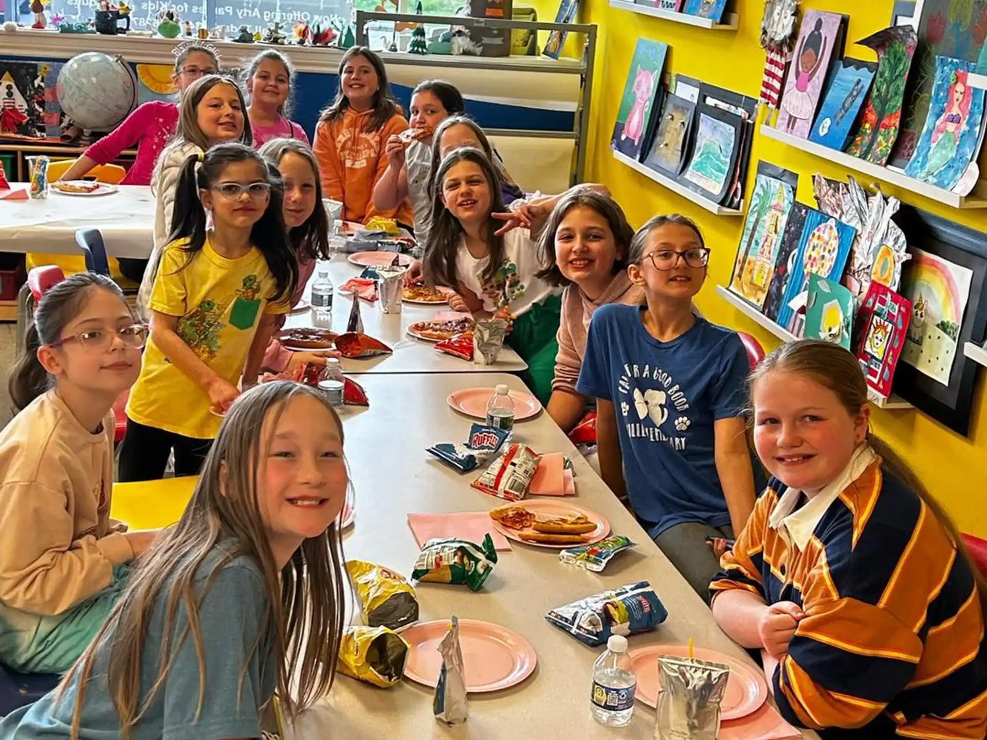 a group of children sitting at a table
