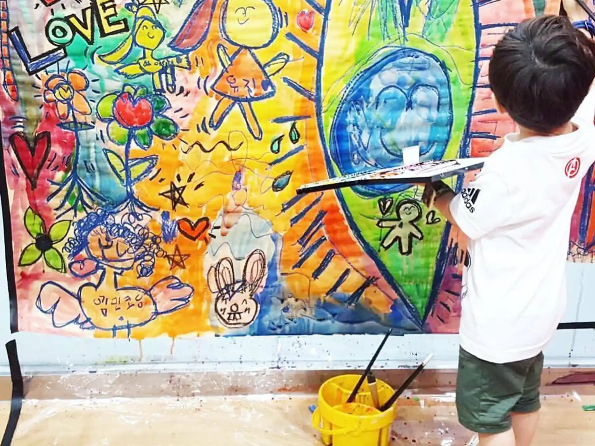a child painting a mural