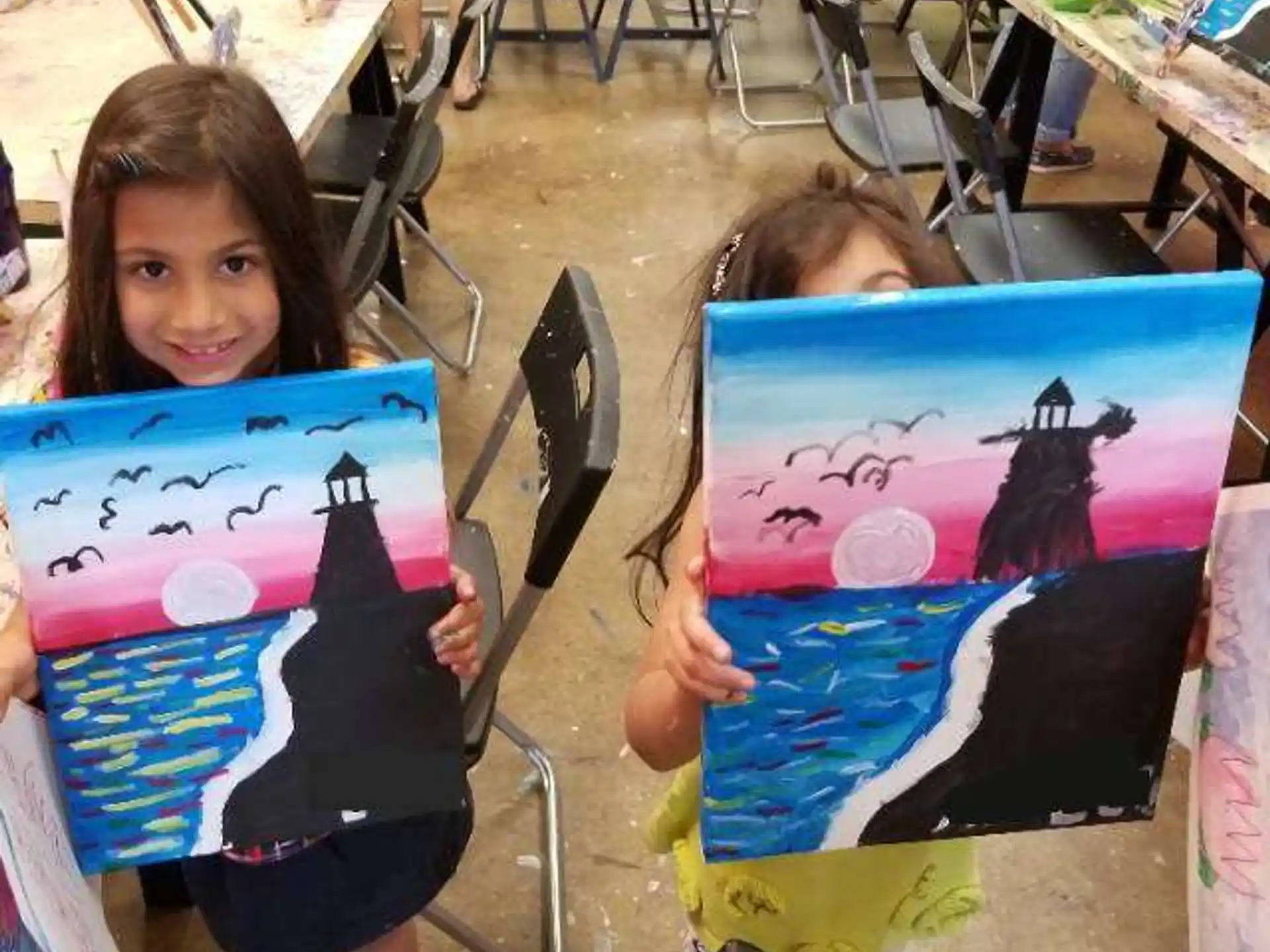 a girl holding a drawing