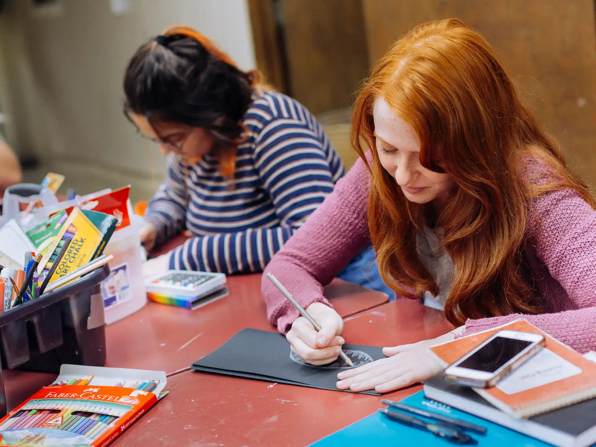 a couple of girls working on a project