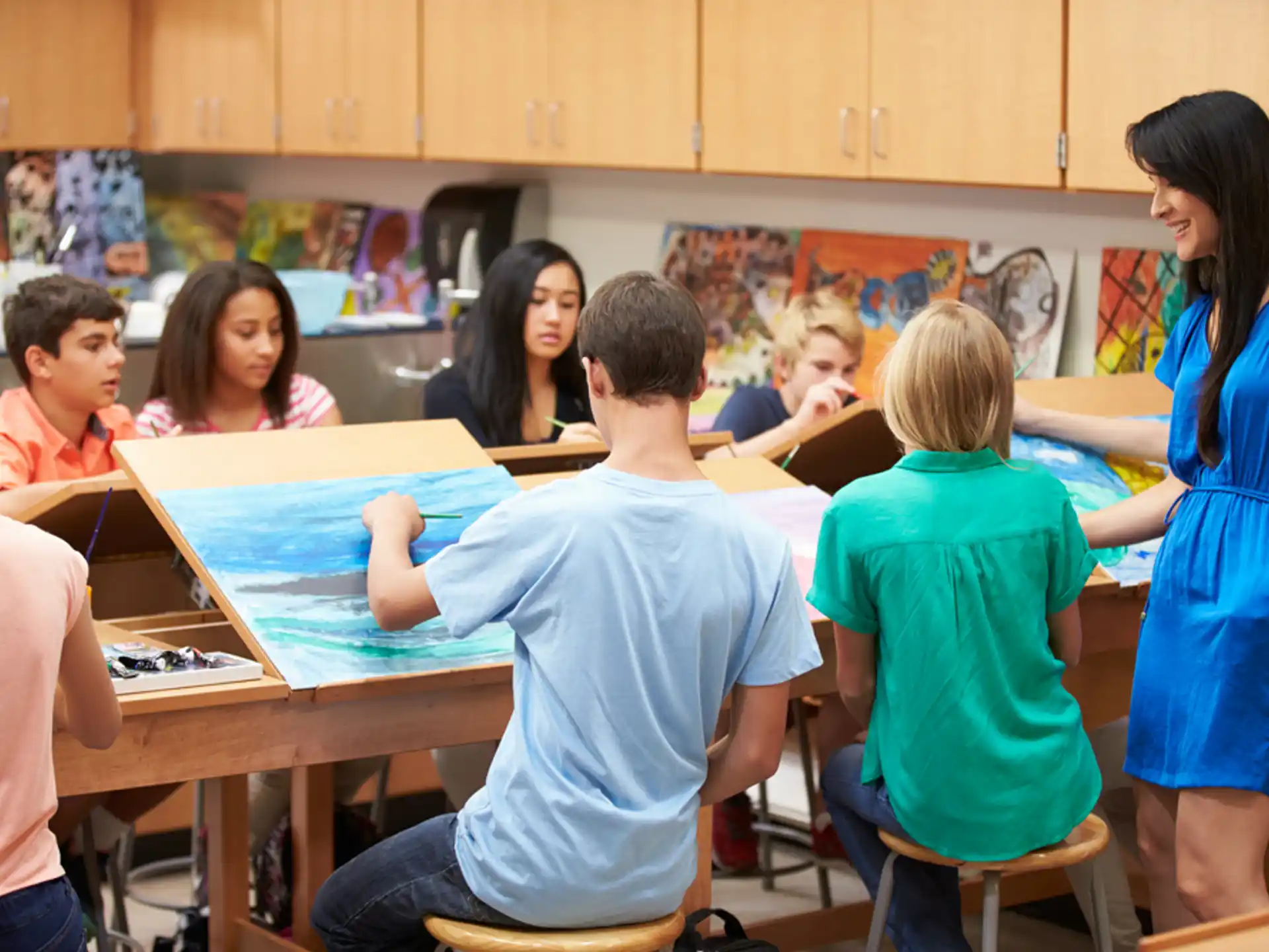 a group of children sitting at a table in a classroom