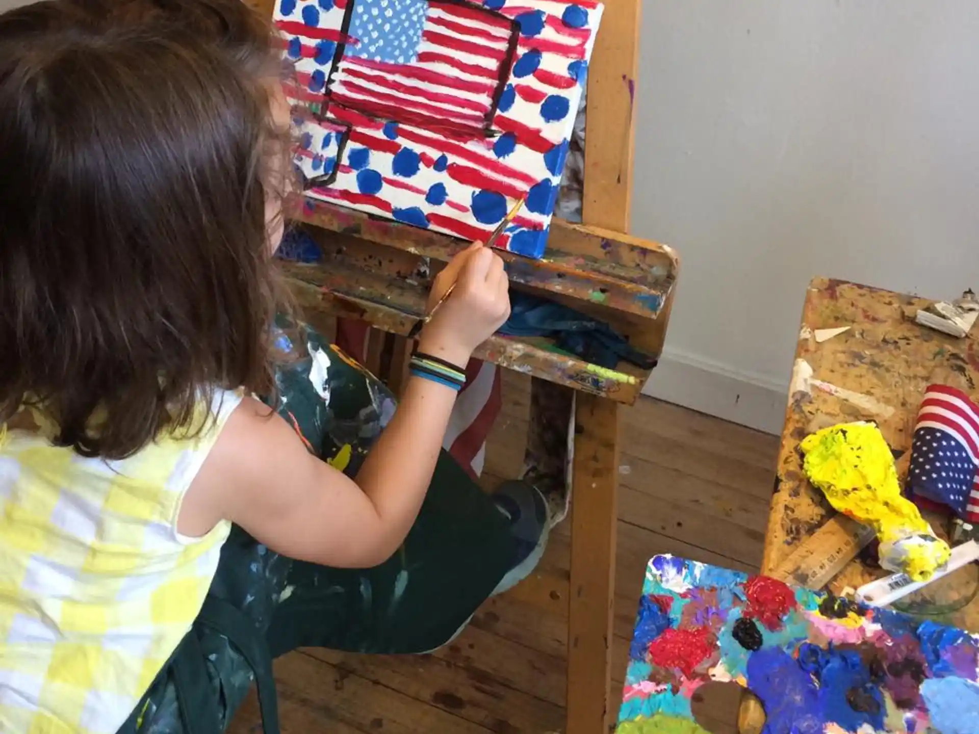 a child sitting on a chair with a gift box