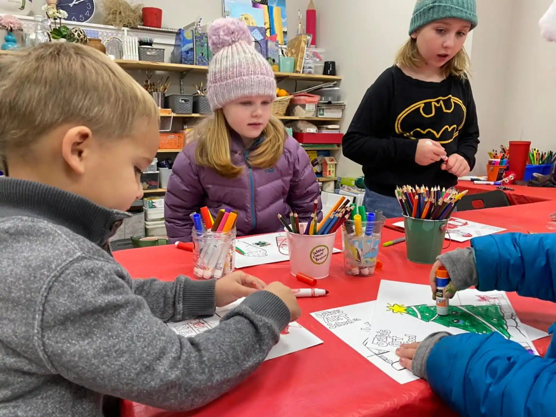 a group of children sitting at a table