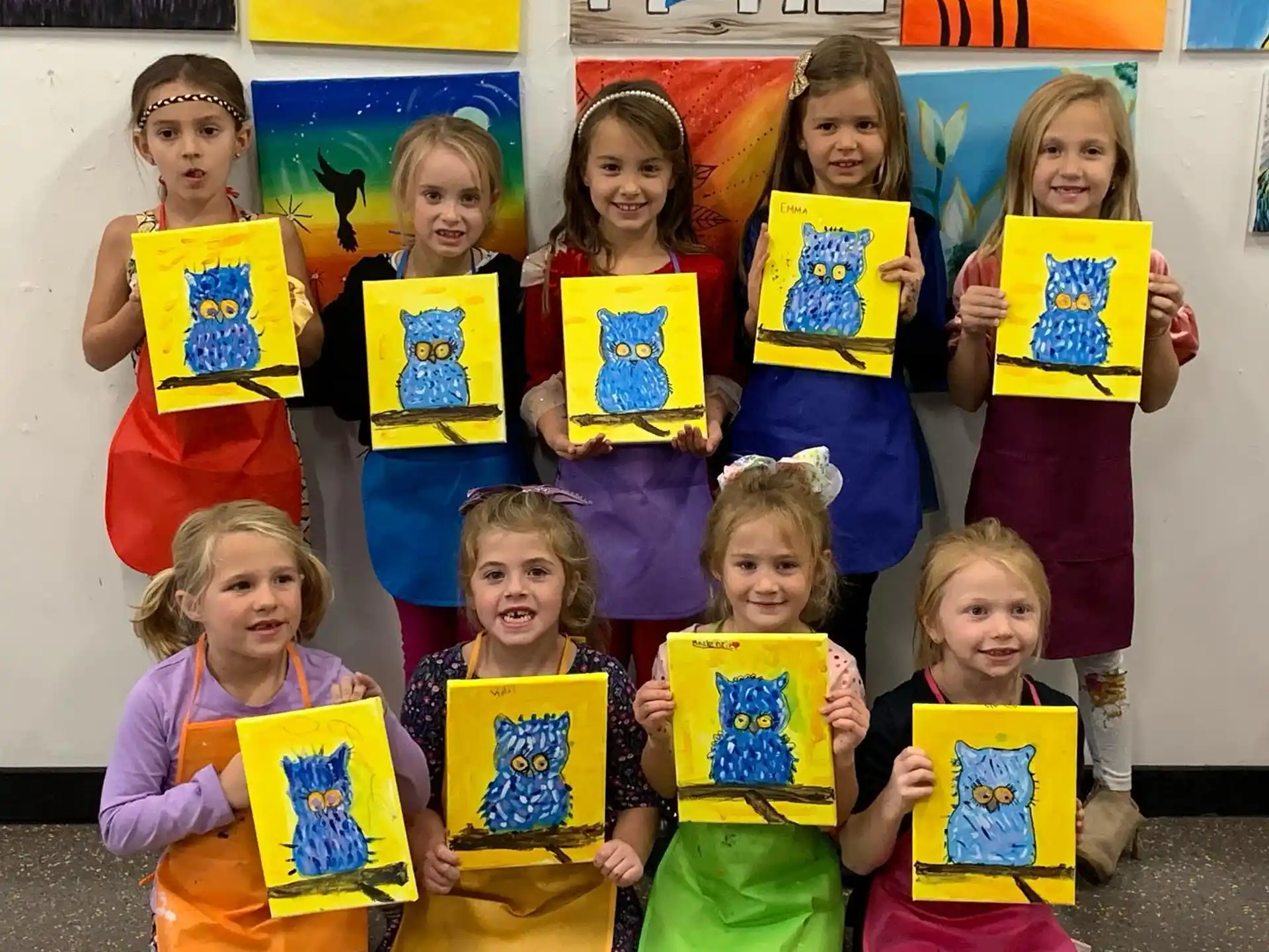 a group of children holding up yellow and blue signs