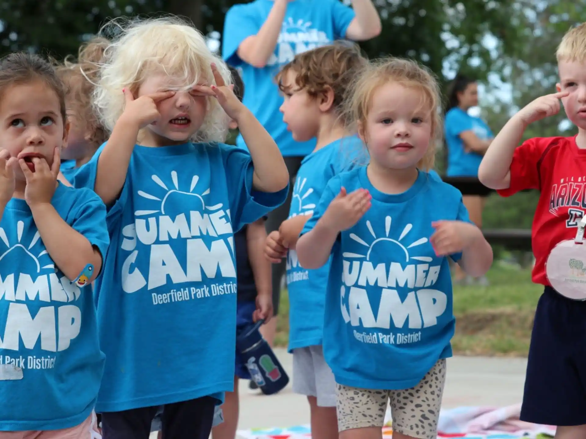 a group of children in blue shirts