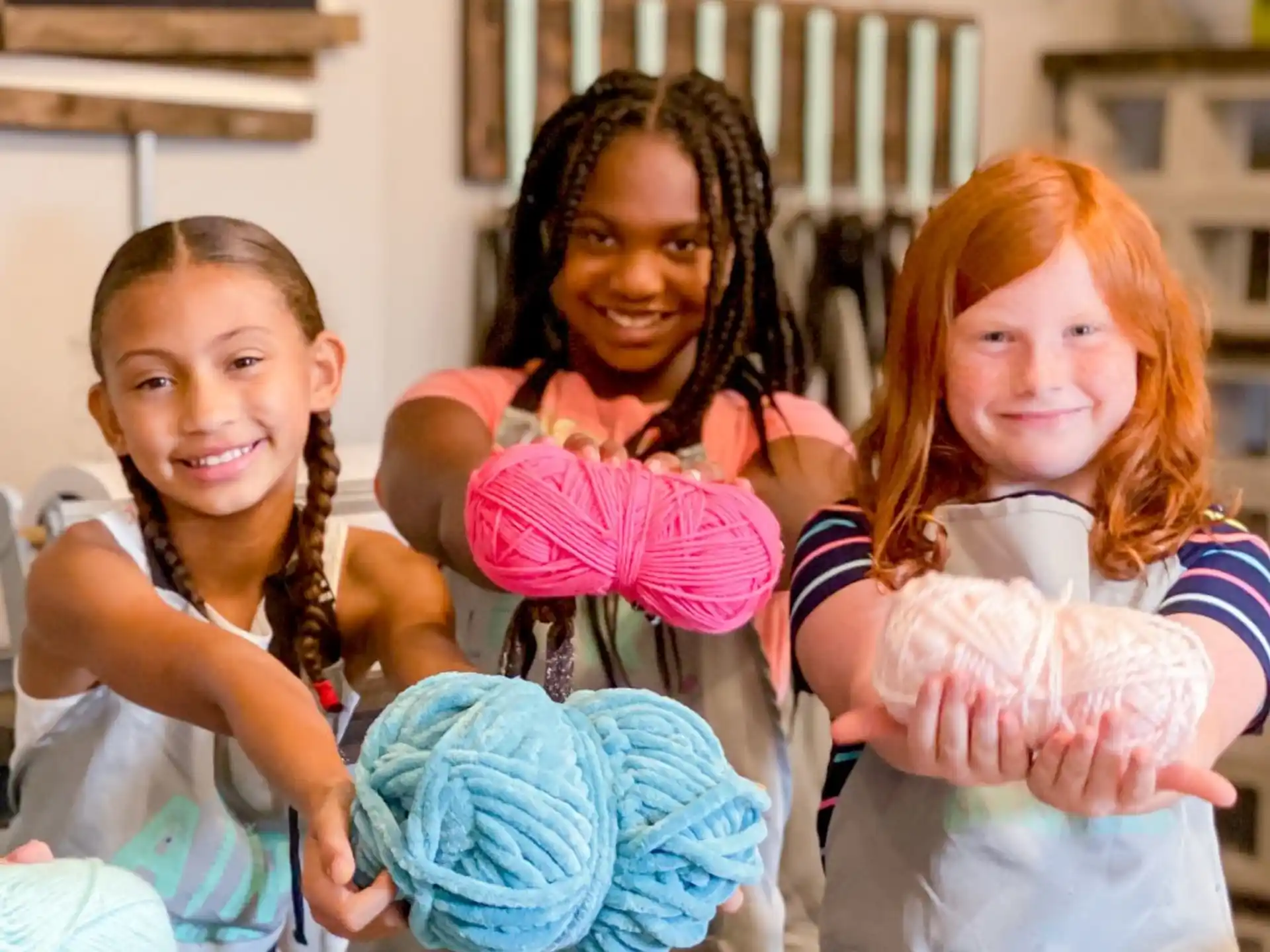 a group of girls holding a stuffed animal