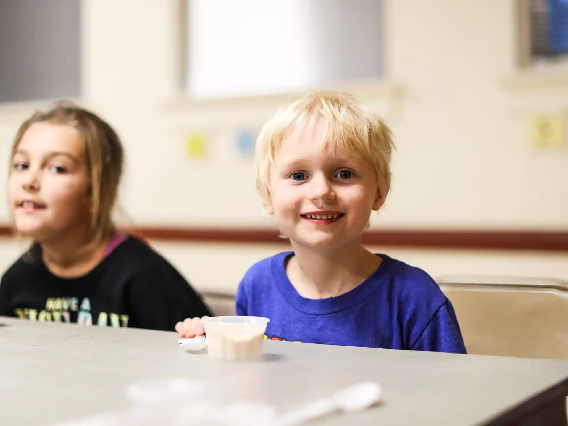a couple of children sitting at a table