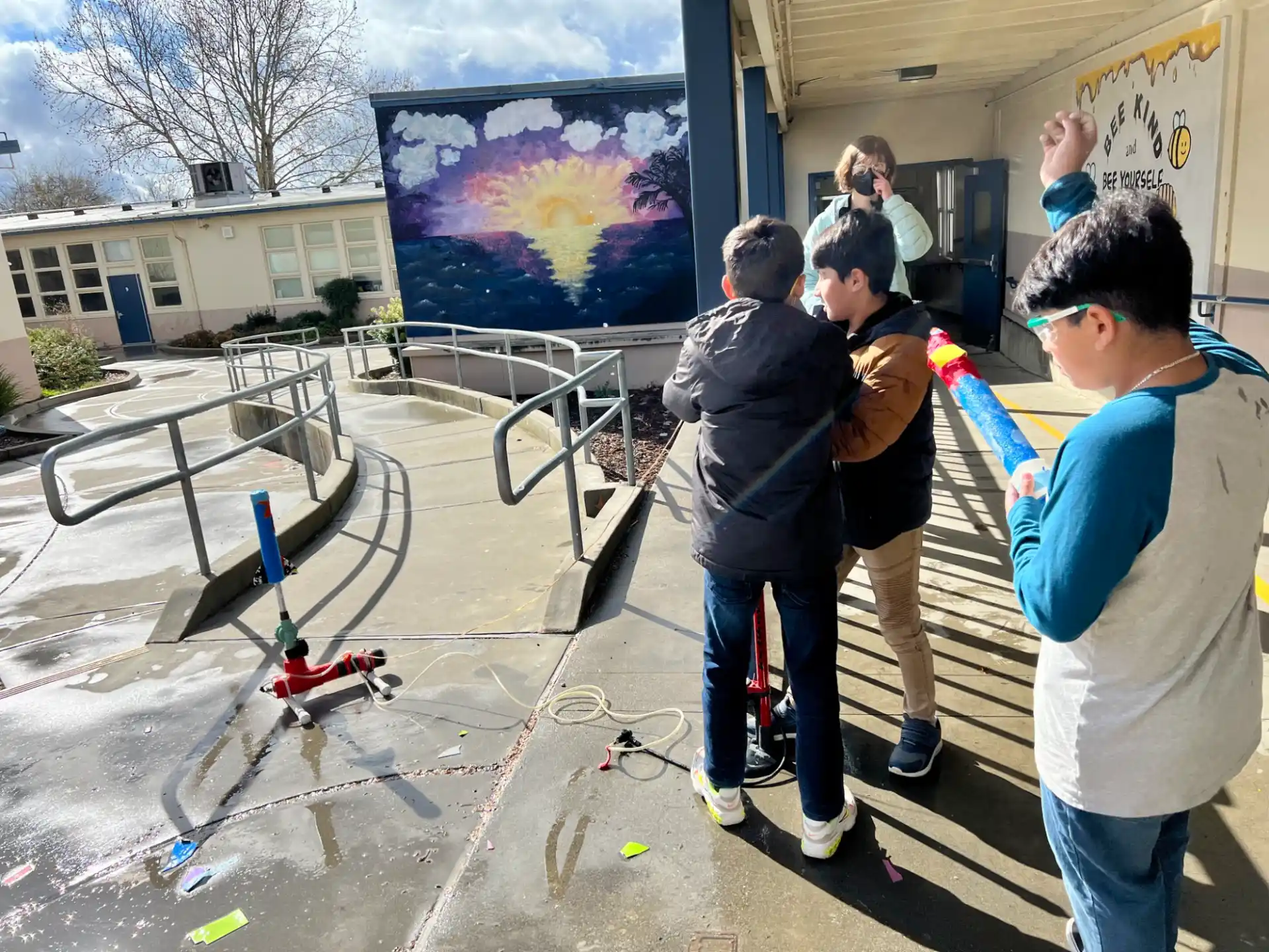 a group of people standing around a model airplane