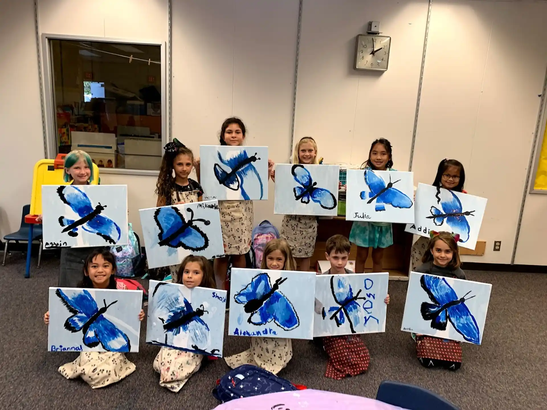 a group of children holding up posters