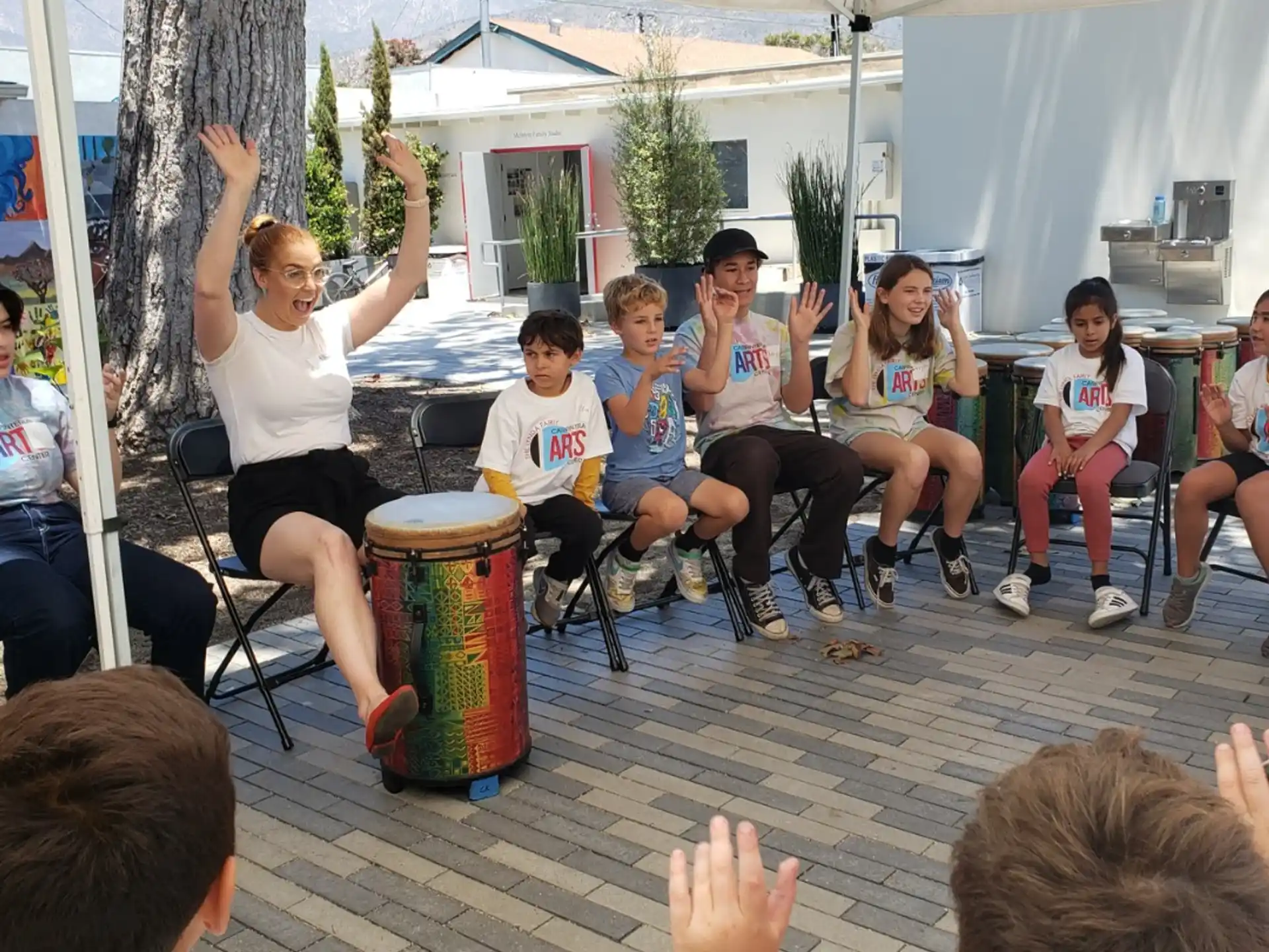 a group of people sitting under a tent