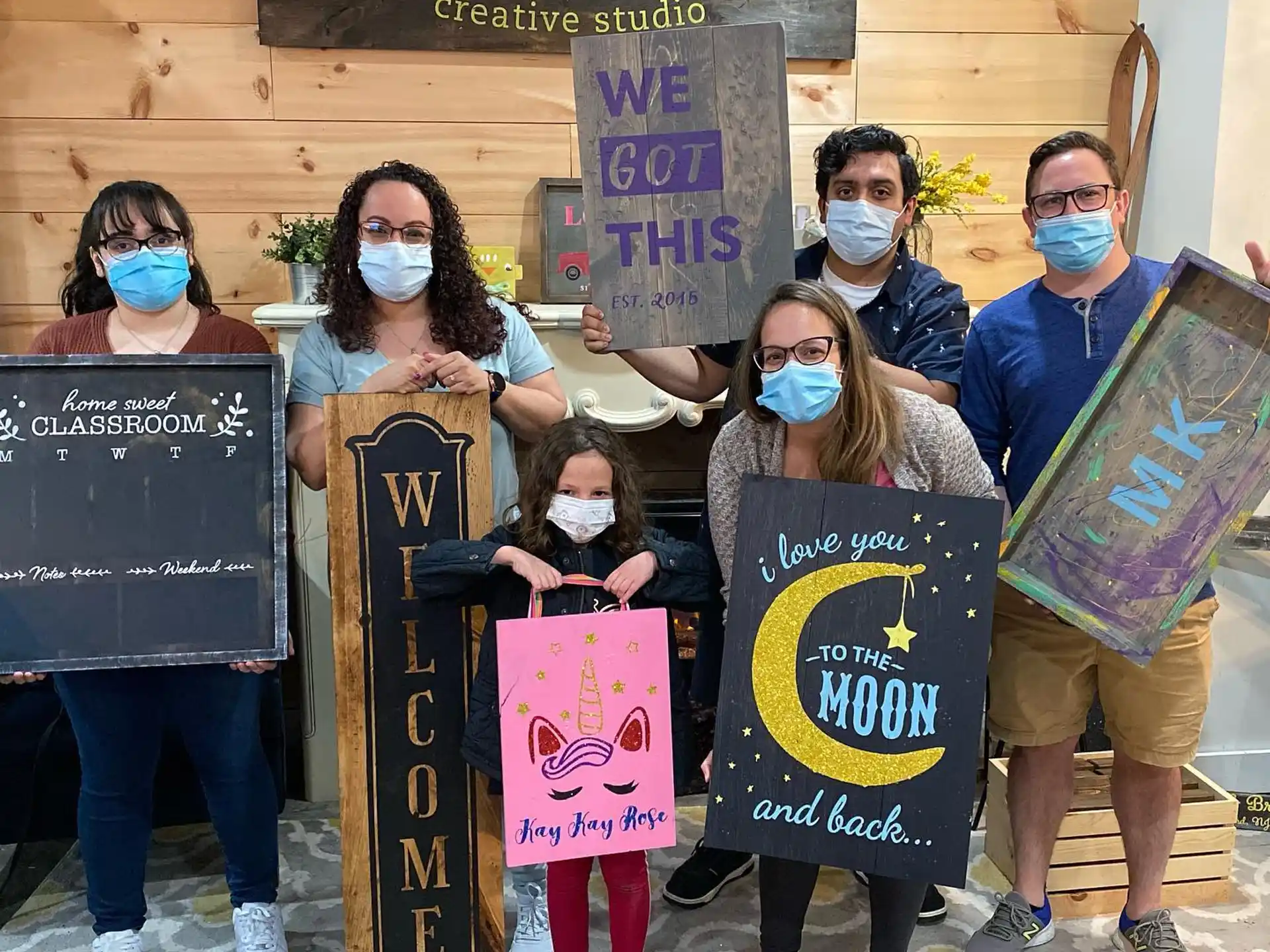a group of people wearing masks and holding signs